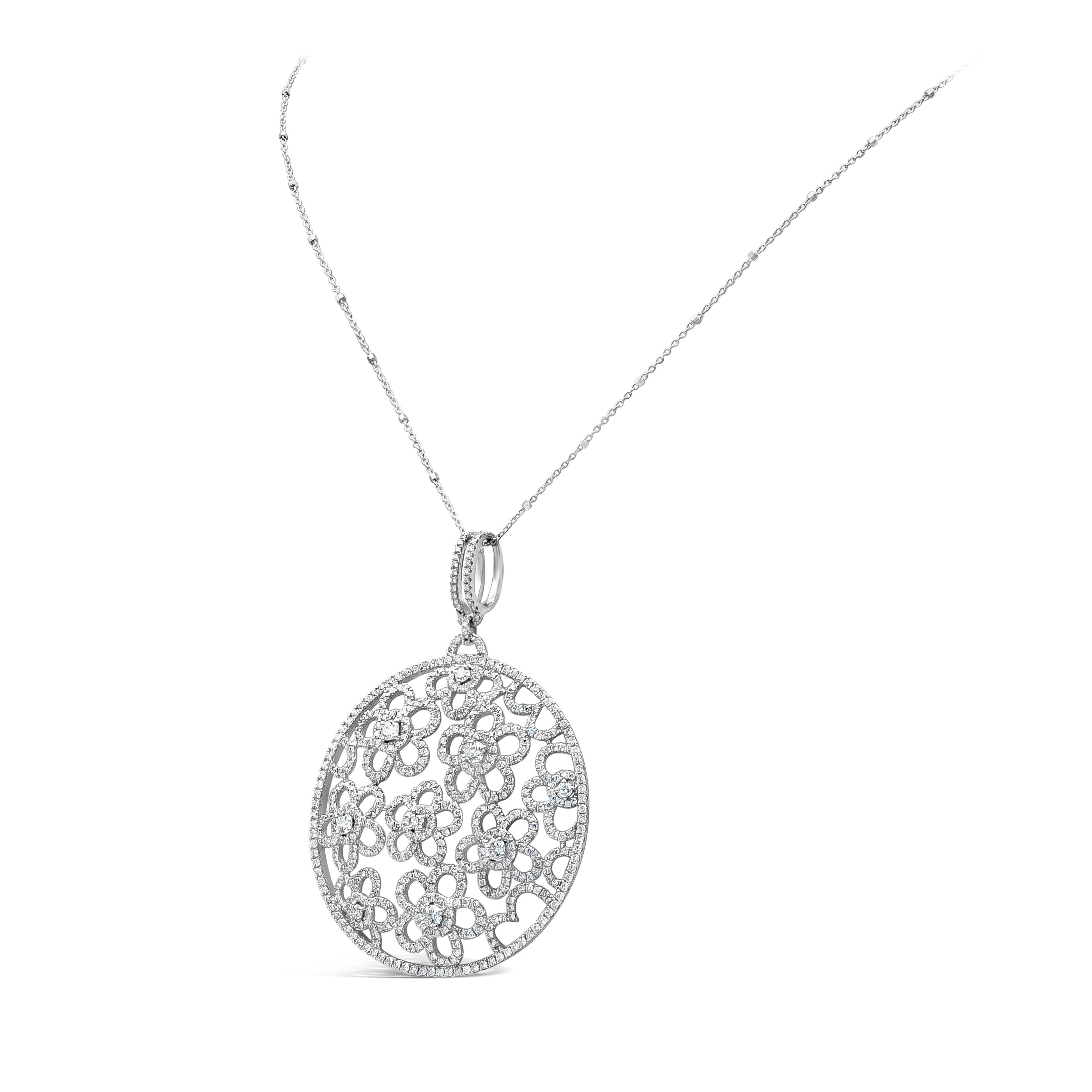 A stylish circular pendant necklace showcasing an open work floral-motif design, featuring 3.92 carats total of brilliant round diamonds. Set in micro-pave and prong setting, Made with 18K white Gold, suspended on 18 inches white gold chain. Chain