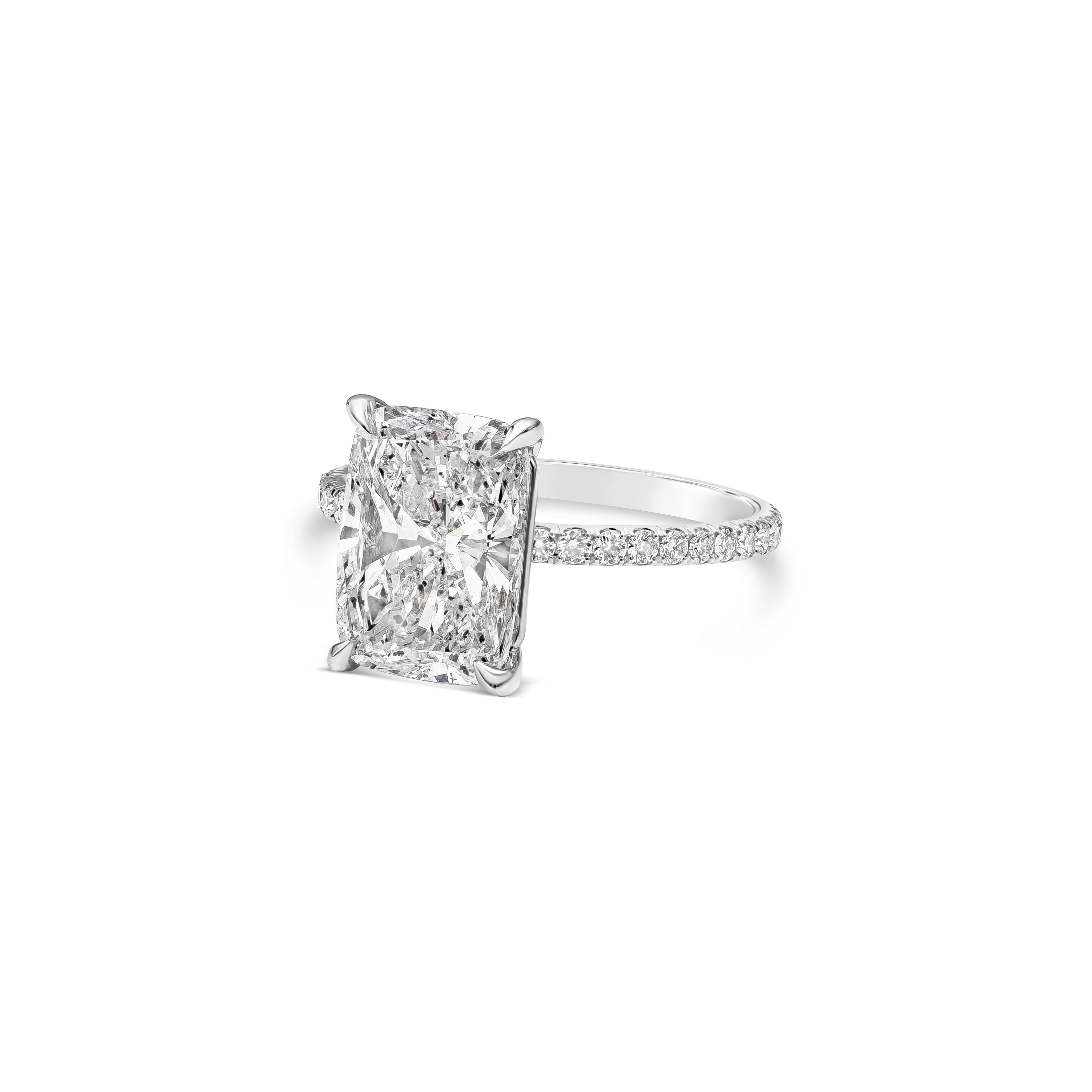 A classic and elegant piece of jewelry showcasing a GIA Certified 4.02 carat elongated cushion cut diamond, D Color and I1 in Clarity. 28 accent brilliant round diamonds are set 3/4 way down the band  approximately 0.32 carats total, E Color and SI1