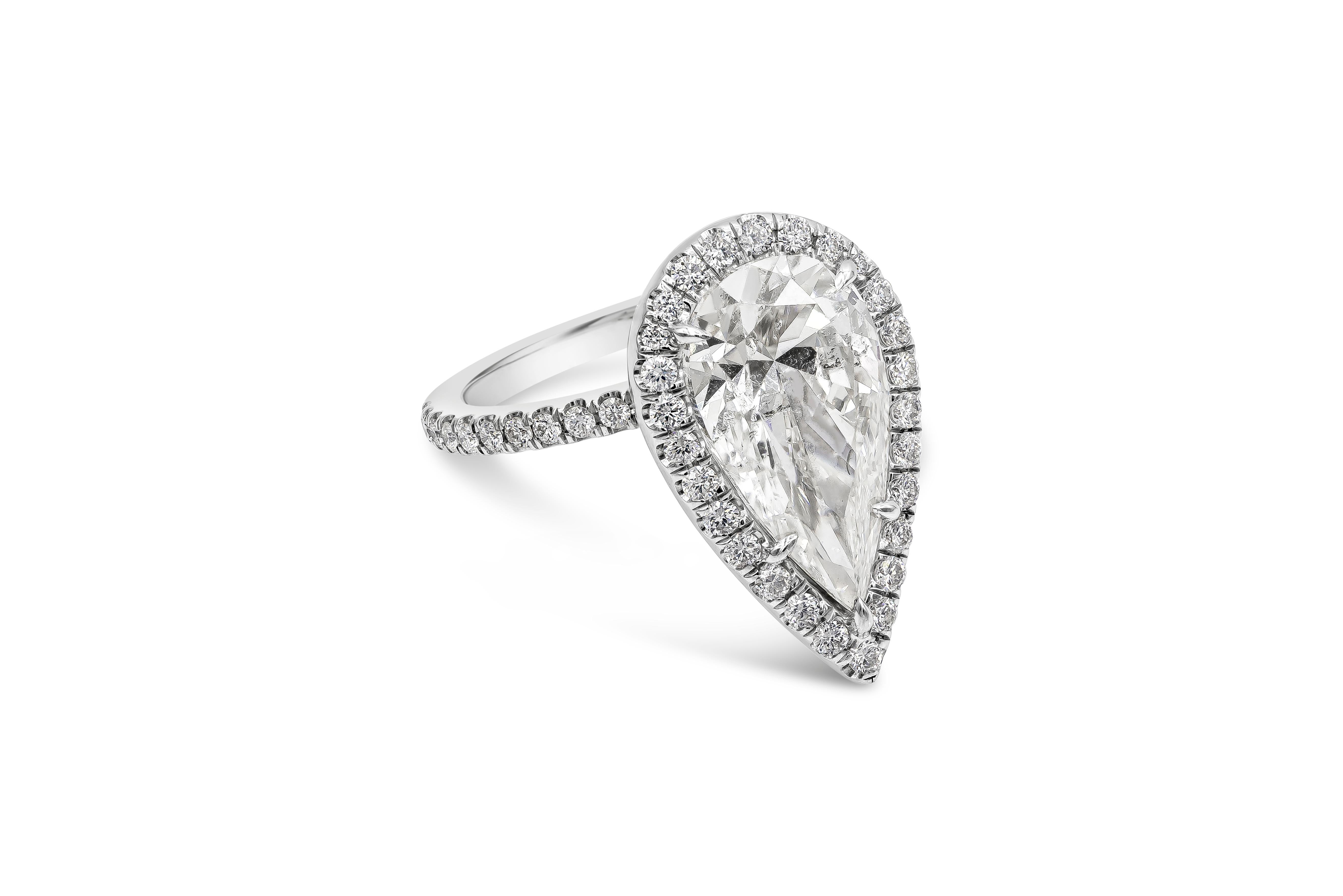 A timeless engagement ring style showcasing a 4.03 carat elongated pear shape diamond certified by EGL USA as G color, SI2 clarity. Center stone is set in a brilliant and delicate diamond surmount, in a polished platinum mounting accented with round