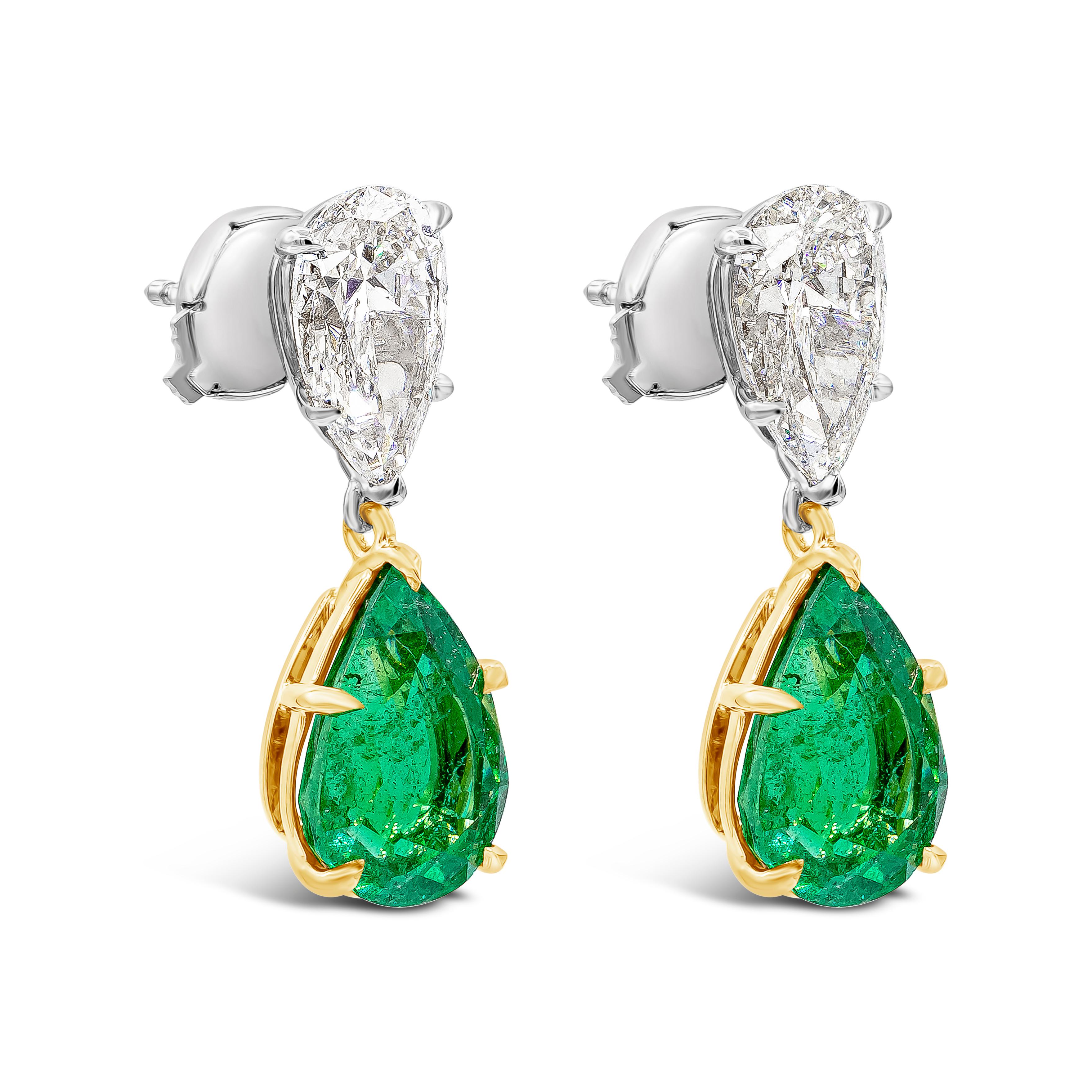 A simple yet elegant pair of earrings showcasing a vibrant pear shape green emeralds weighing 4.18 carats total, SI in clarity. Each suspended on an inverted pear shape diamond weighing 2.12 carats total, H color and SI in clarity. Made in 18K