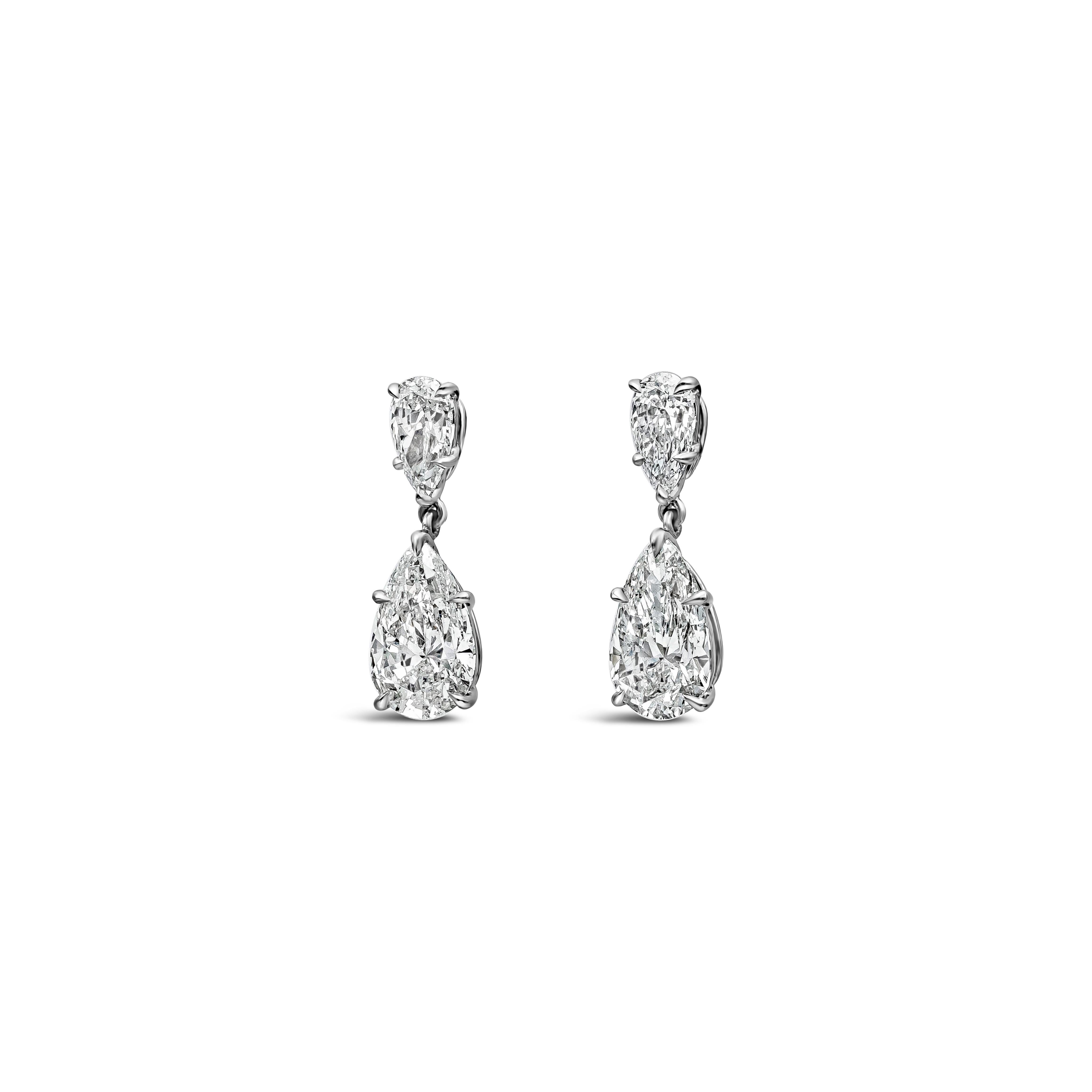 A classy pair of dangle earrings featuring two GIA Certified pear shape diamond weighing 3.20 carats total, F-G Color and SI2 in Clarity. Suspended on another pear shape diamond weighing 1.01 carats total, E-F Color and VS-SI in Clarity. SI in