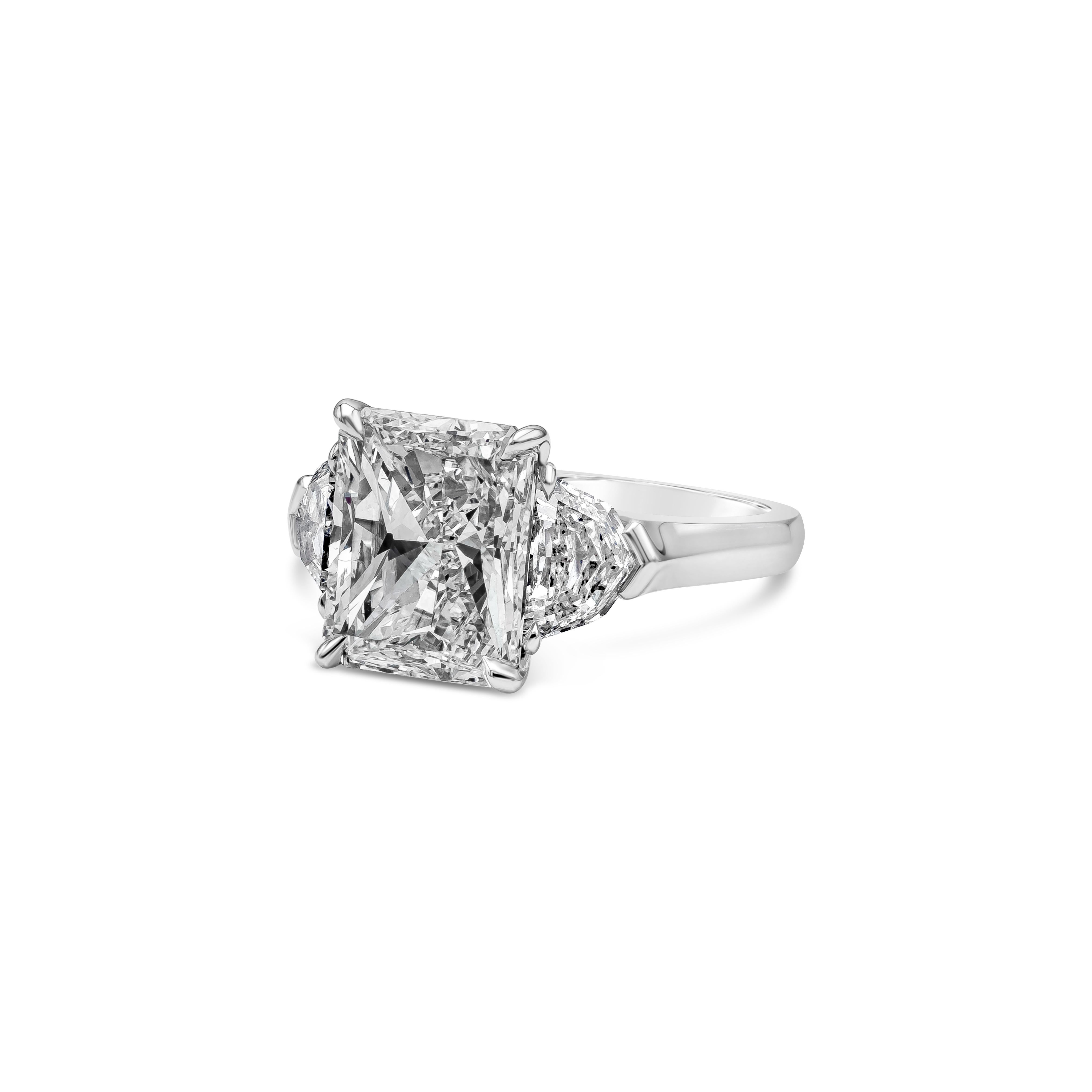 This elegant three stone engagement ring features a GIA Certified 4.53 carat radiant cut diamond center stone, J Color and VS2 in Clarity. Flanking the center stone are 2 epaulette diamonds, weighing 1.45 carats total, J Color and VS in Clarity.