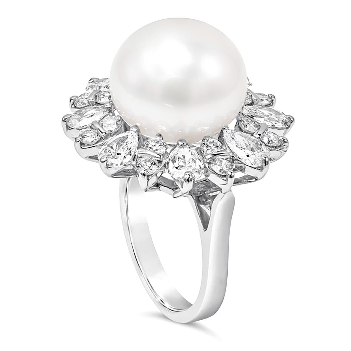 A beautiful cocktail ring showcasing a 14.50mm white south sea pearl, set in a brilliant diamond halo made of pear shape and round diamonds. diamonds weigh 4.60 carats total, Set and made in 18K White Gold. Size 6.75 US resizable upon