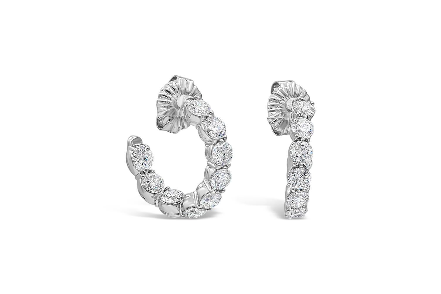 A unique hoop earrings style showcasing a row of round brilliant diamonds weighing 4.79 carats total, F Color and SI2 in Clarity. Diamonds are set in a curved inside-out with shared prong setting. Finely made in 18K White Gold.

Style available in