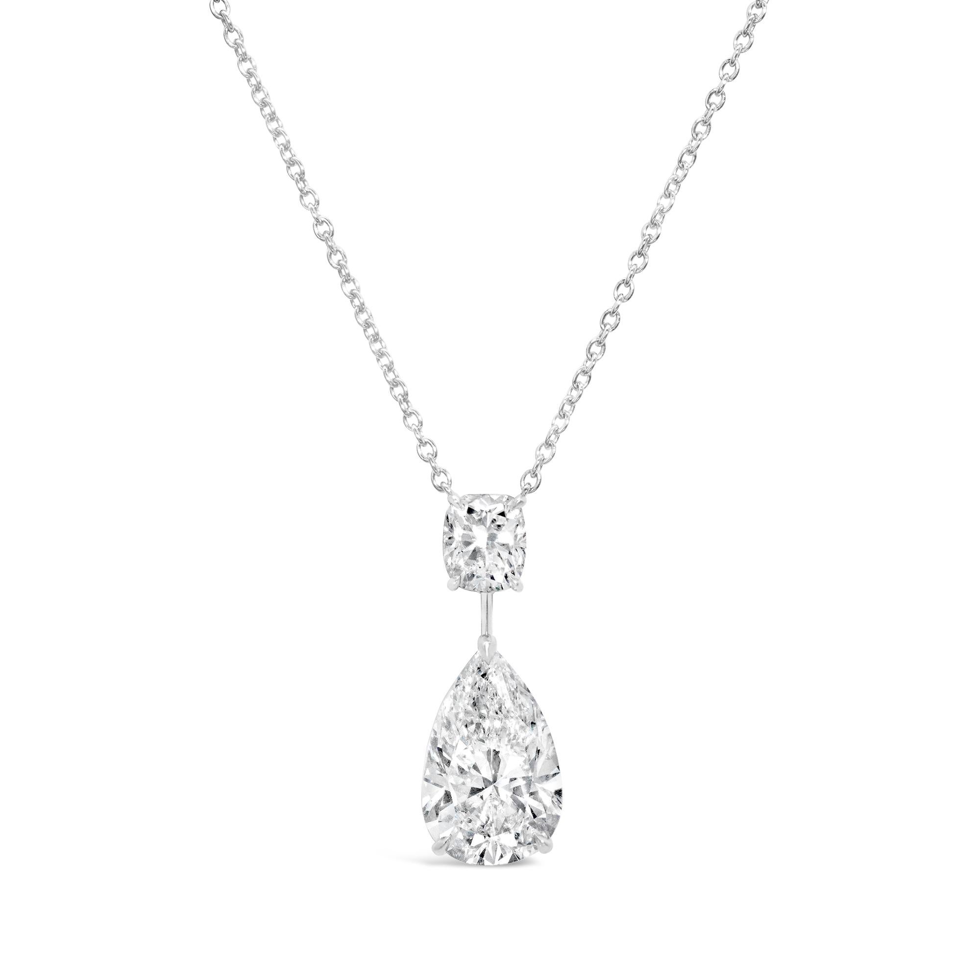 A beautiful pendant diamond necklace, showcasing a 4.02 carat pear shape diamond with F color and VS2 clarity, set on a three prong setting. Accented by a 1.00 carat cushion cut diamond with E color and SI clarity, set on a four prong setting.