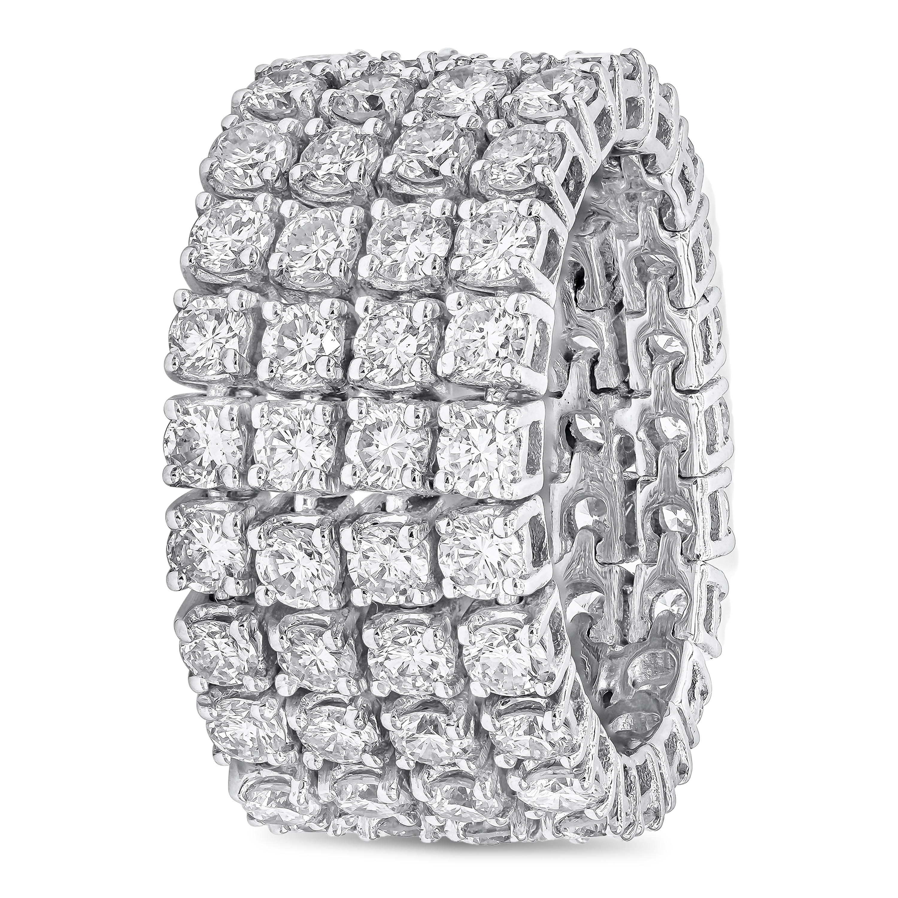 This fashionable and vibrant flexible wedding band showcases four rows of 84 brilliant round diamonds weighing 5.10 carats total, set in a classic four prong basket setting. Finely made in 18K white gold. Size 6.5 US resizable upon request and