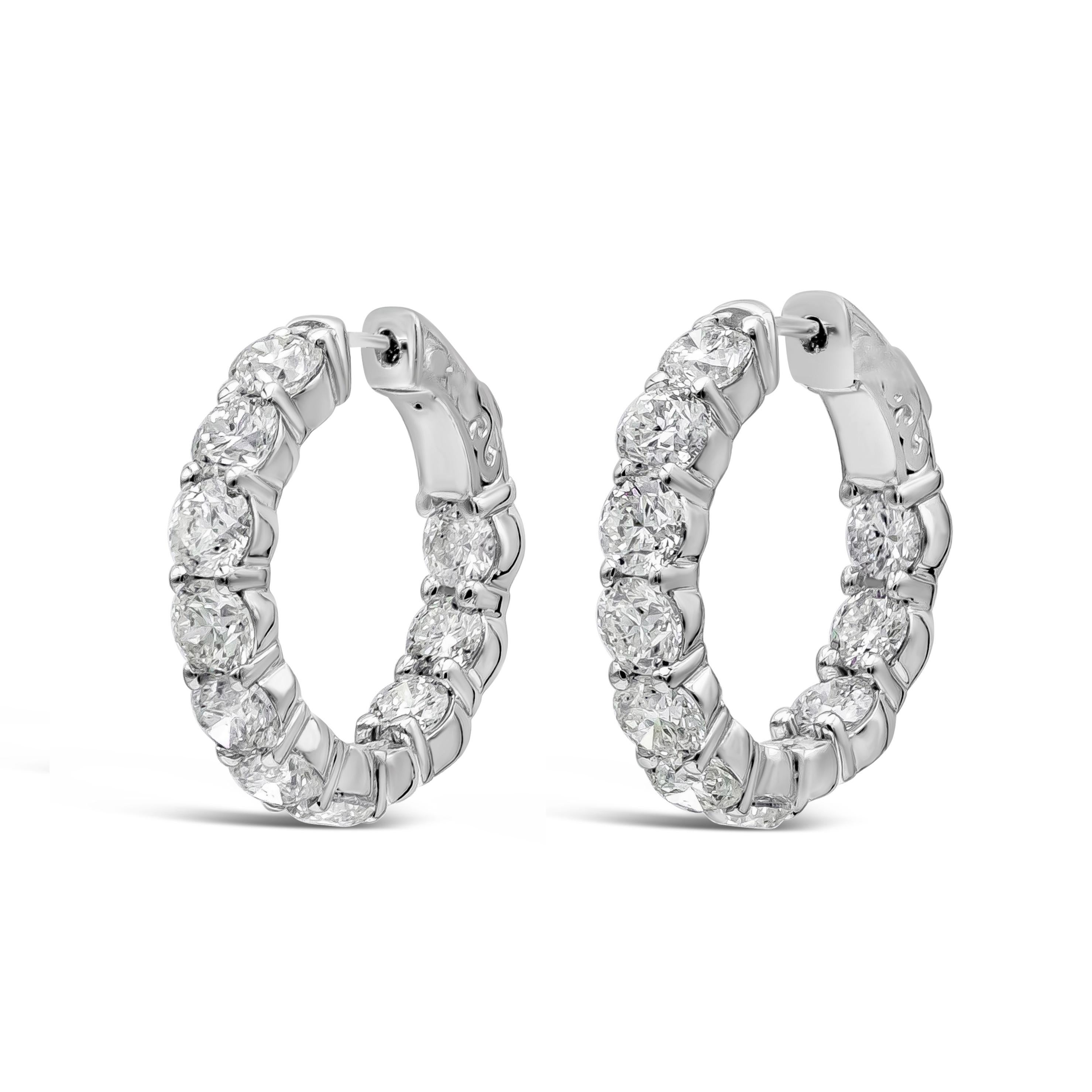 A classic and versatile style hoop earrings showcasing 20 round brilliant diamonds, set in a scalloped pave style made in 14k white gold. Diamonds are 5.35 carats total, H color and SI in clarity. 0.90 inch diameter.

Style available in different