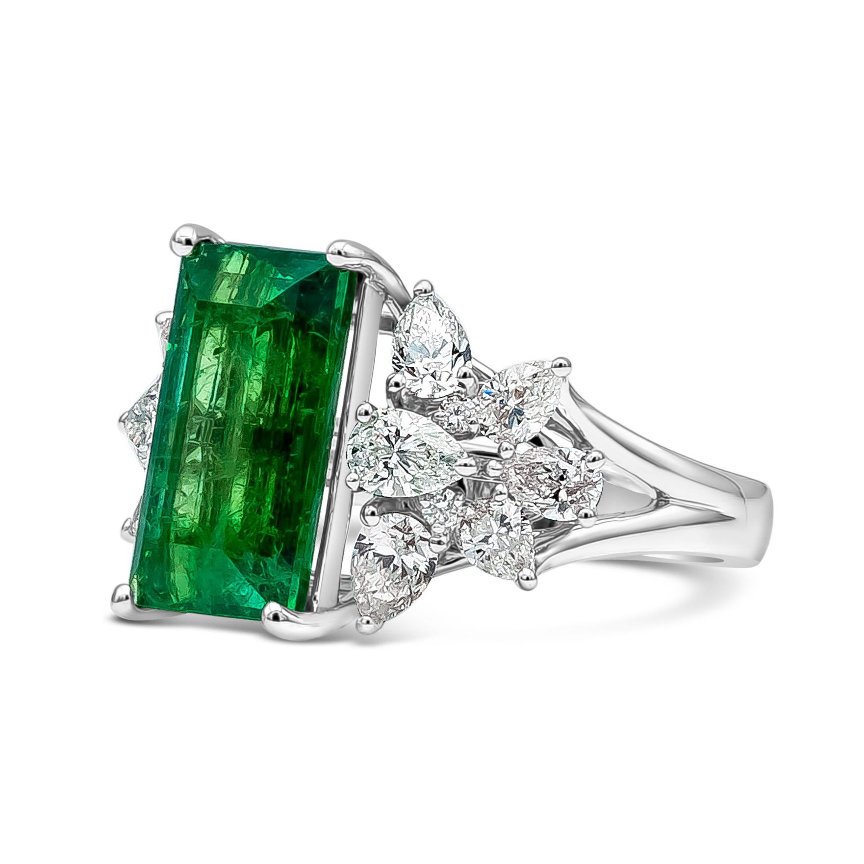 Well crafted high end jewelry fashion ring featuring GRS certified 5.40 carat baguette cut green emerald gemstone. 12 pear shape diamonds weighing 1.99 carat total and 4 bright round diamonds weighing 0.05 carat total accents the center gemstone