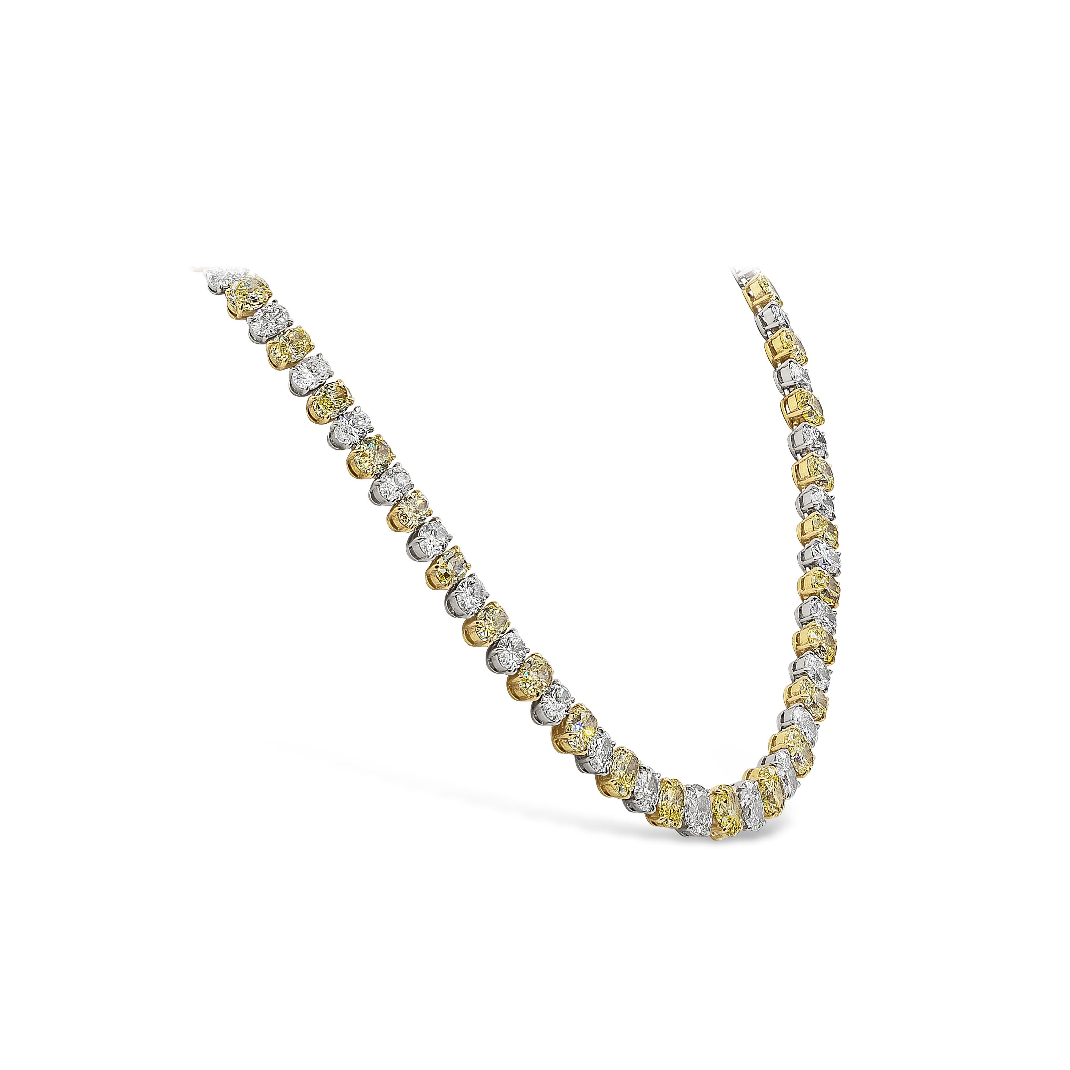 Spectacular piece of high end jewelry necklace showcasing 43 color-rich oval cut fancy yellow diamonds weighing 31.14 carat total, set in a four prong 18k yellow gold setting. Elegantly alternating with 43 brilliant oval cut white diamonds weighing