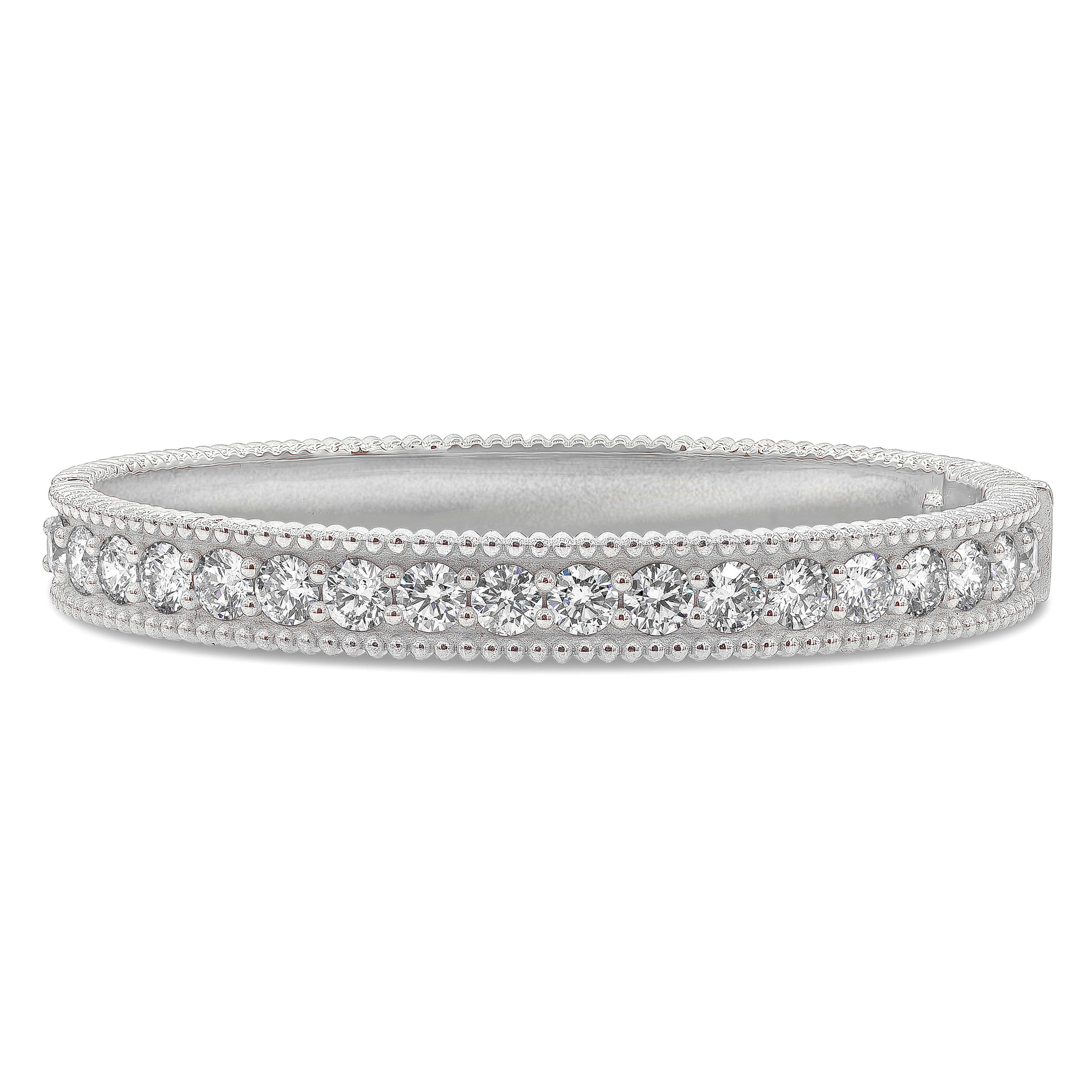 A brilliant and stylish bangle bracelet showcasing a row of brilliant round diamonds weighing 5.49 carats total, E-F Color and SI in Clarity. Set in a flushed shared prong setting. Finely made and crafted with beaded edges in 18K White Gold.

Roman