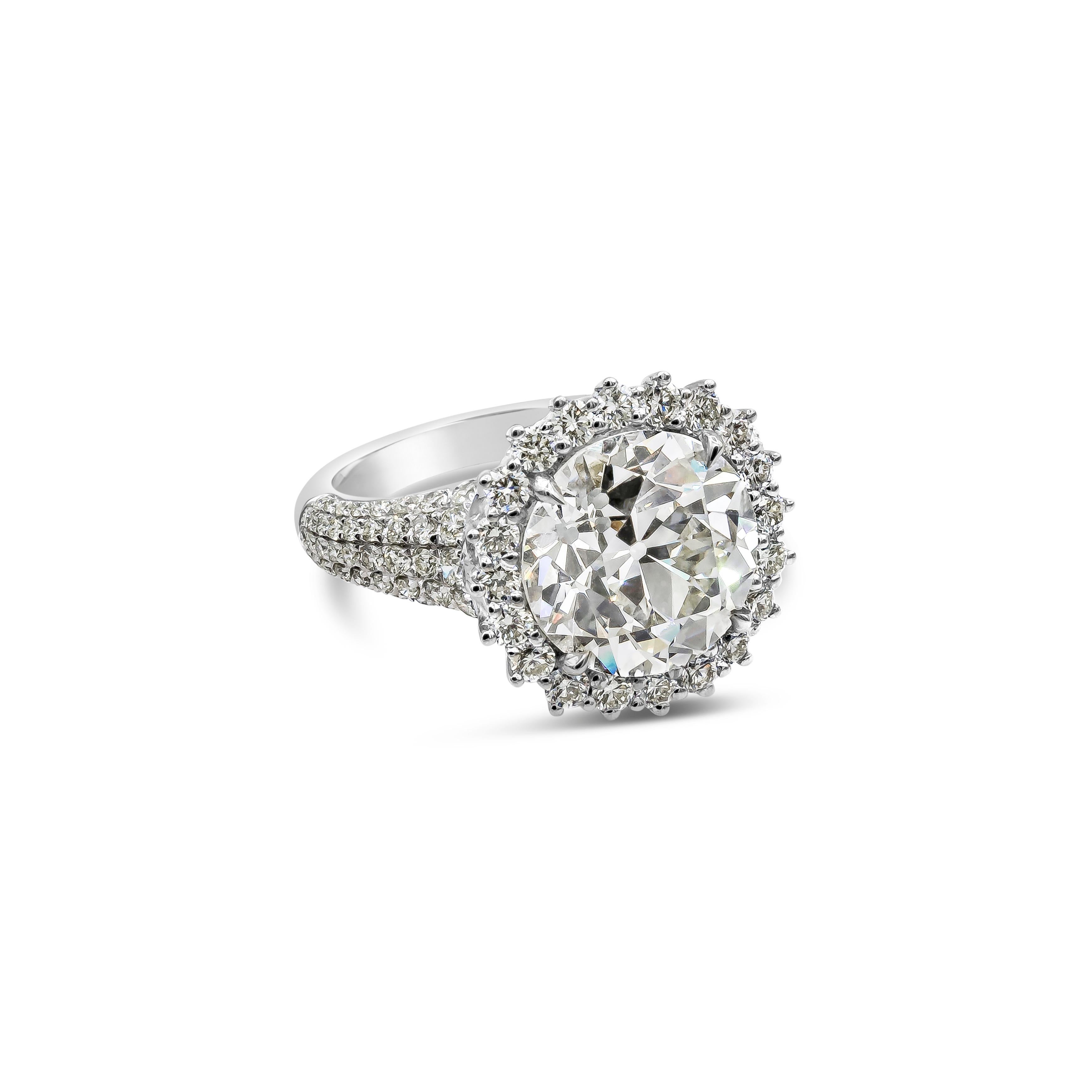 A unique and brilliant piece of jewelry featuring a 5.56 carats old European cut diamond, certified by GIA as M color, VS2 in clarity. Surrounded by a single row of round brilliant diamonds. Set in a micro-pave diamond shank setting. Accent diamonds
