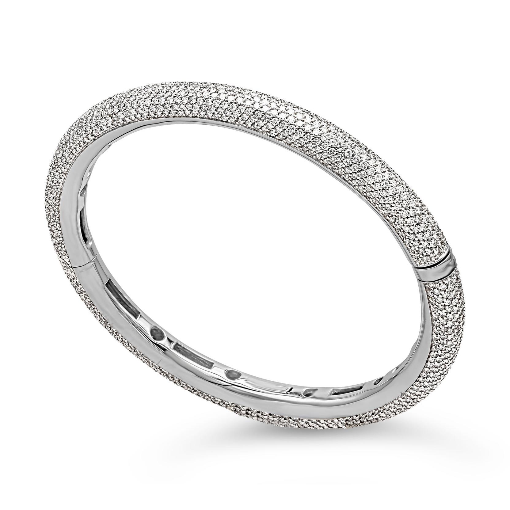 A classic hinge bangle bracelet showcasing a cluster of brilliant round diamonds, weighing 5.78 carats total, F Color and VS in Clarity. Set in a rounded micro-pave setting and Finely made in 18K White Gold.

Roman Malakov is a custom house,