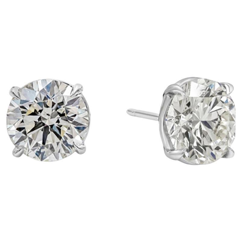 A classic pair of stud earrings showcasing two round brilliant diamonds, each weighing 3.06 carats and 3.02 carats, J-K in Color and SI1-VS2 in Clarity. Set in a simple four prong basket setting, Finely made in 18K White Gold.

Roman Malakov is a