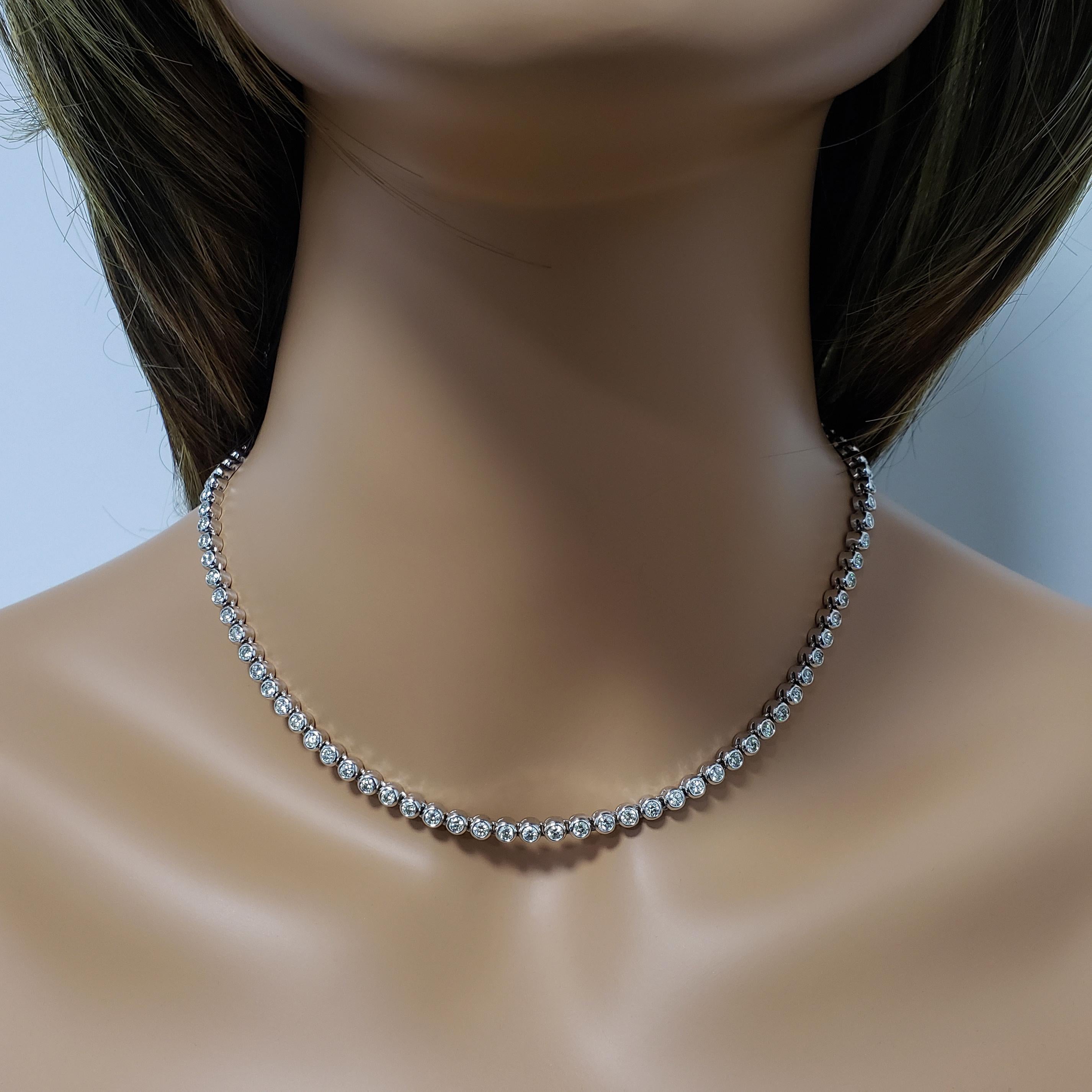 A classic and timeless tennis necklace showcasing round brilliant diamonds set in a bezel made in 14k white gold. Diamonds weigh 6.15 carats total.

Style available in different price ranges. Prices are based on your selection. Please contact us for