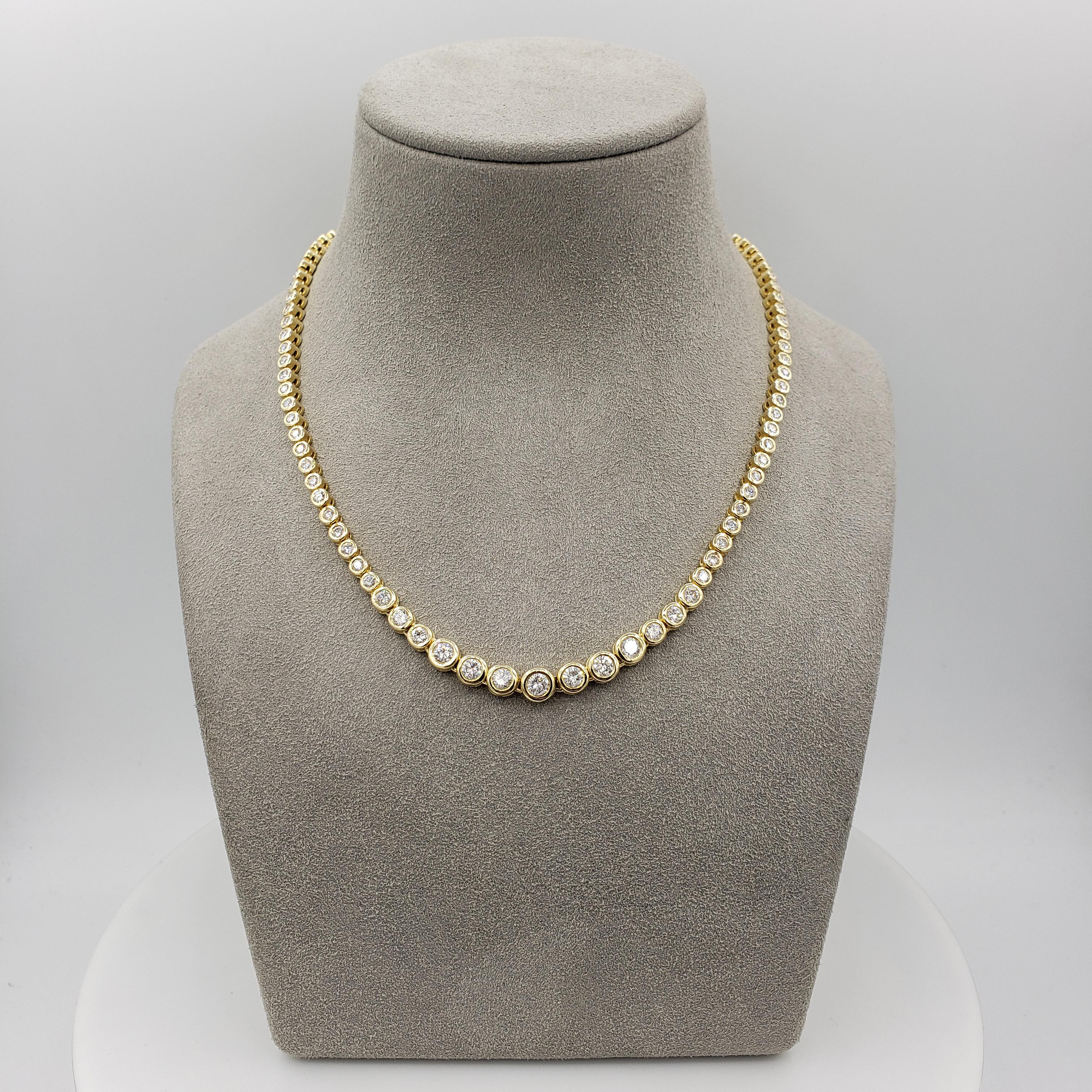 A classic and versatile tennis necklace showcasing a row of round brilliant diamonds that graduate larger as it drops to the center of the necklace. Each diamond is bezel set in 14k yellow gold. Diamonds weigh 6.17 carats total.

Style available in