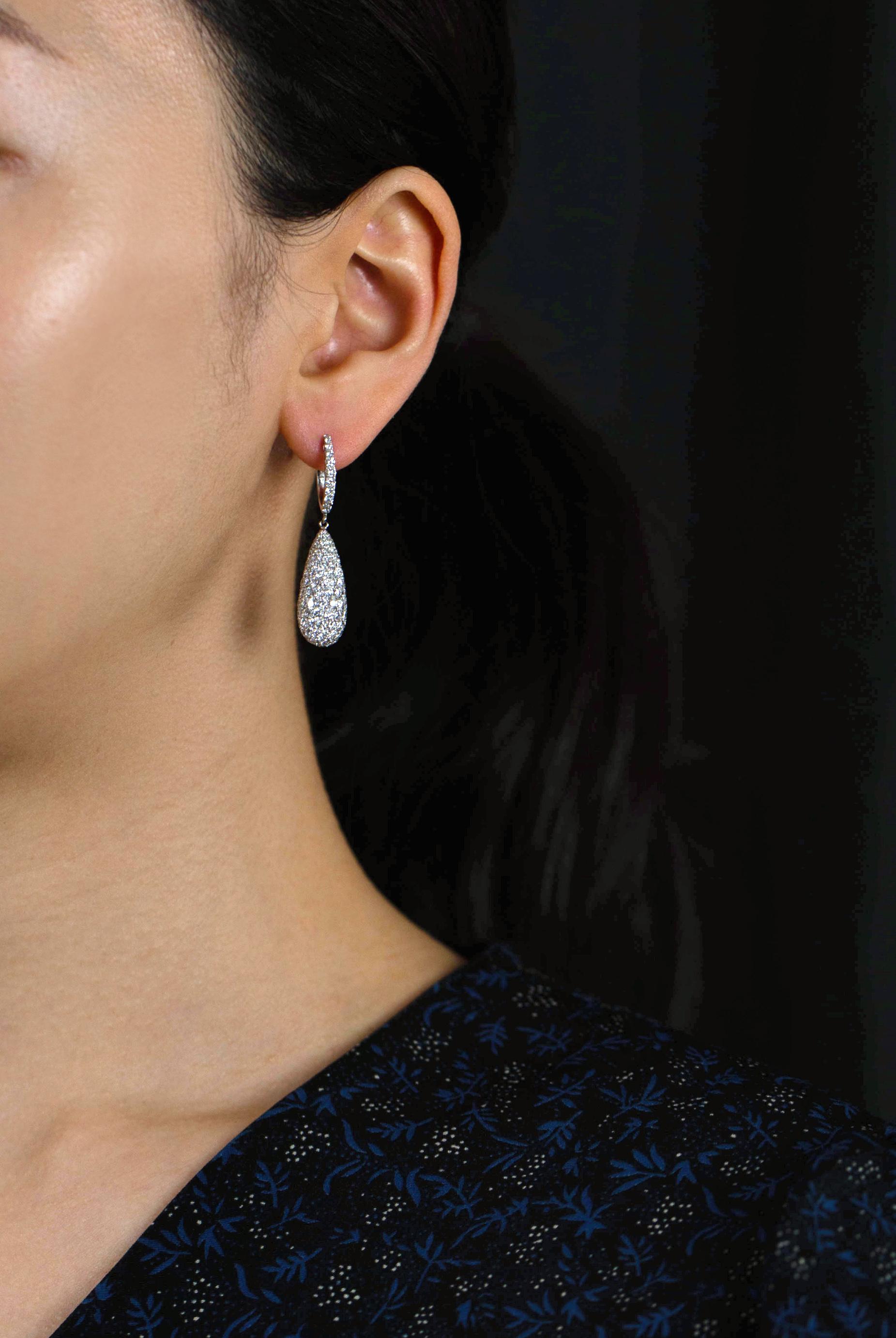 A brilliant and lustrous pair of dangle earrings showcasing a 6.33 carats of round brilliant diamonds, set in a elegant micro-pave tear drop design. Made in 18K White Gold. 

Roman Malakov is a custom house, specializing in creating anything you can