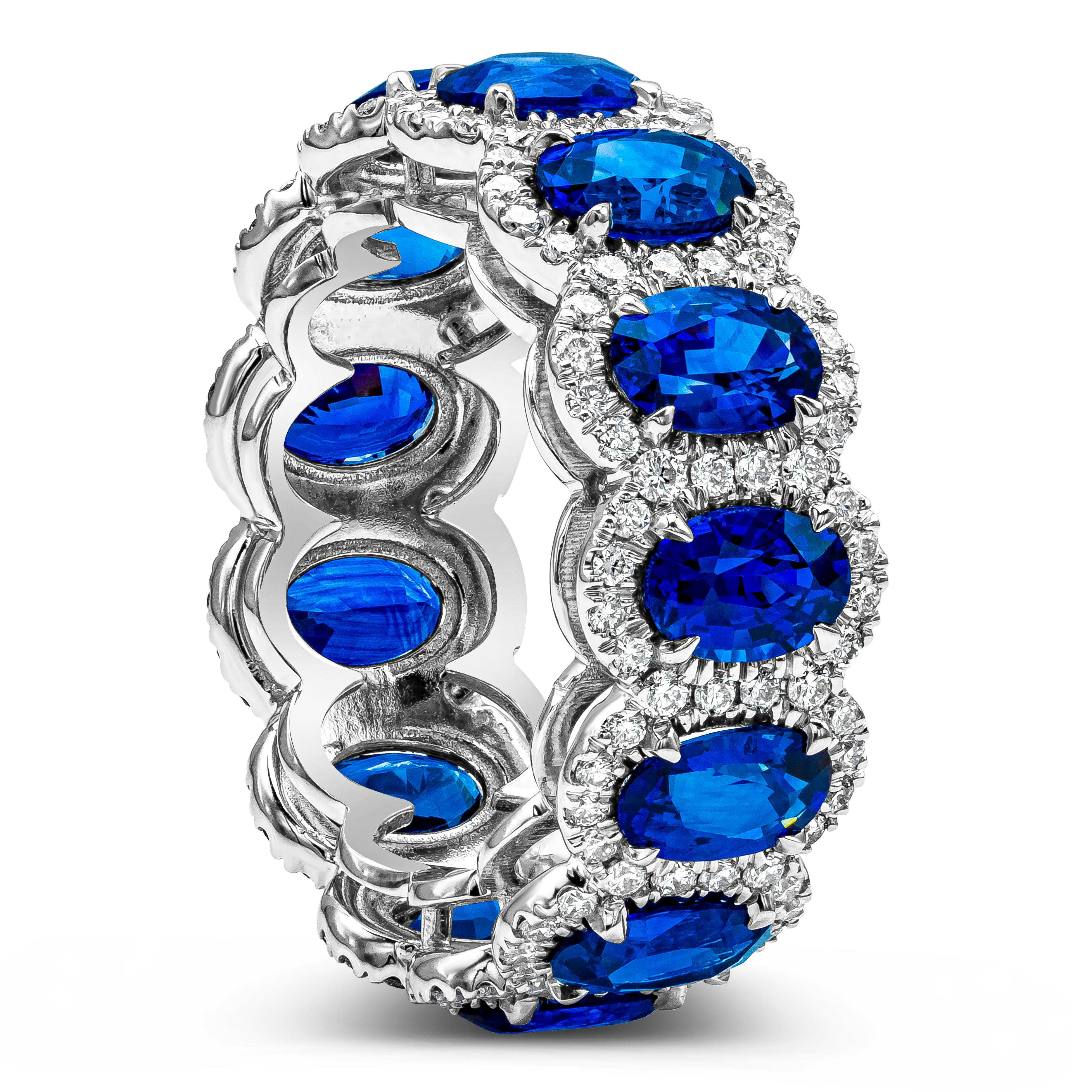 A beautiful eternity wedding band or anniversary ring showcasing a row of oval cut blue sapphires, surrounded by 156 pieces row of round brilliant diamonds. Sapphires weigh 7.18 carats total; diamonds weigh 1.05 carats total. Made with 18K White