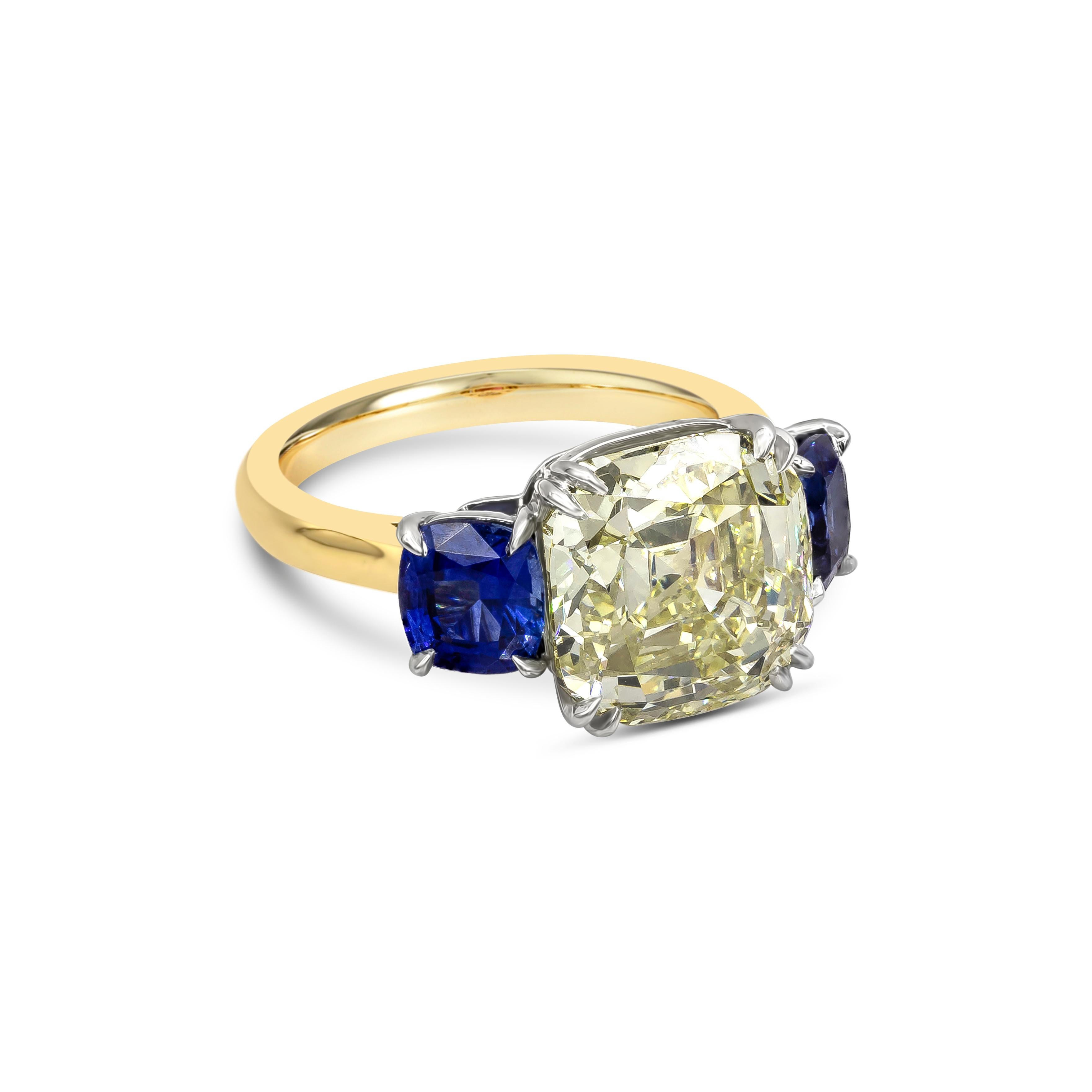 Luxurious and elegantly made high end jewelry three-stone engagement ring showcasing a 7.20 carat antique cushion cut diamond, certified by GIA gemologist as O color, VS2 clarity. Flanking the center diamond are cushion cut blue sapphires weighing