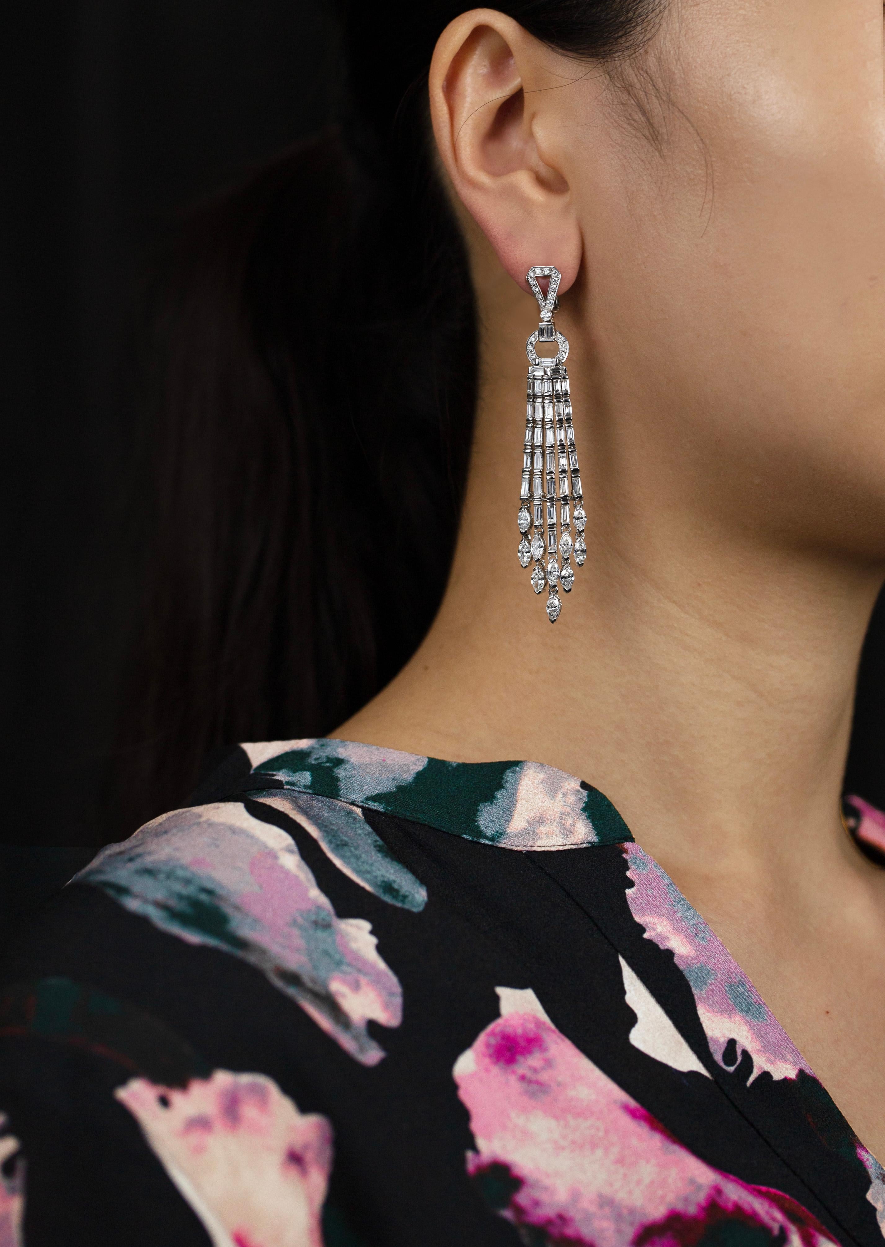 These beautiful chandelier earrings offer a classy and sophisticated look to any style or fashion. The whole earring is encrusted with mixed diamonds but it spotlights 5 diamond encrusted fringes suspended in an open-work circular composition.