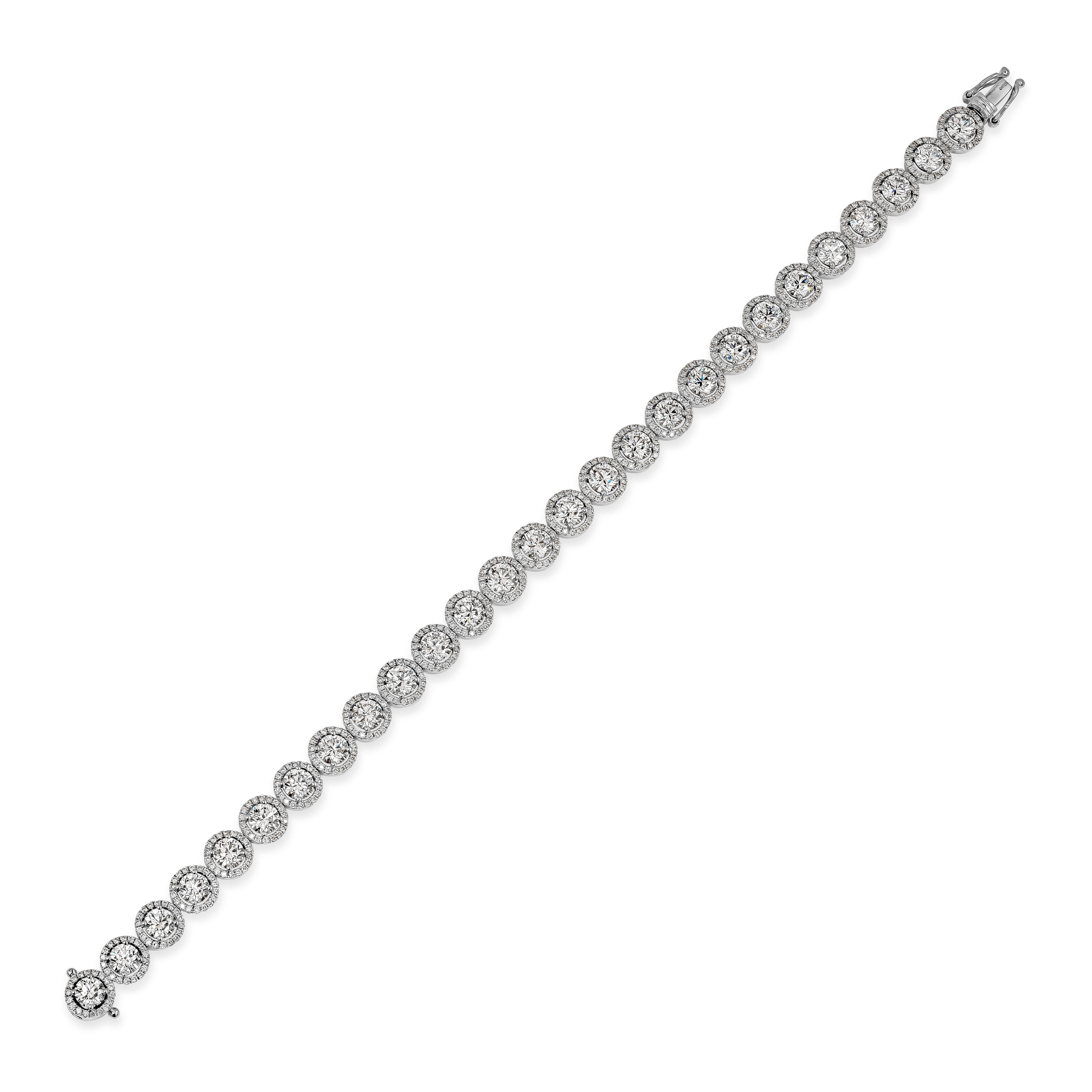 This gorgeous tennis bracelet features 27 round brilliant diamonds weighing 6.47 carats total. Each stone is surrounded by a single row of small round diamonds weighing 1.44 carats total. Made with 18K White Gold. 7.25 inches in Length

Roman