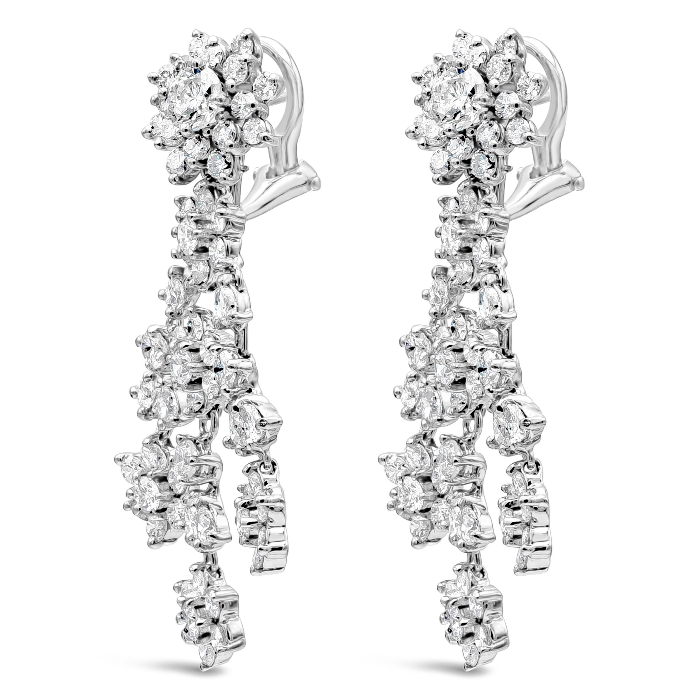 A brilliant pair of dangle earrings showcasing round shape diamonds in a floral-motif design, evenly spaced by round and pear shape diamonds set in an elegant chandelier design. Diamonds weigh 7.98 carats total. Made with 18K White Gold

Style