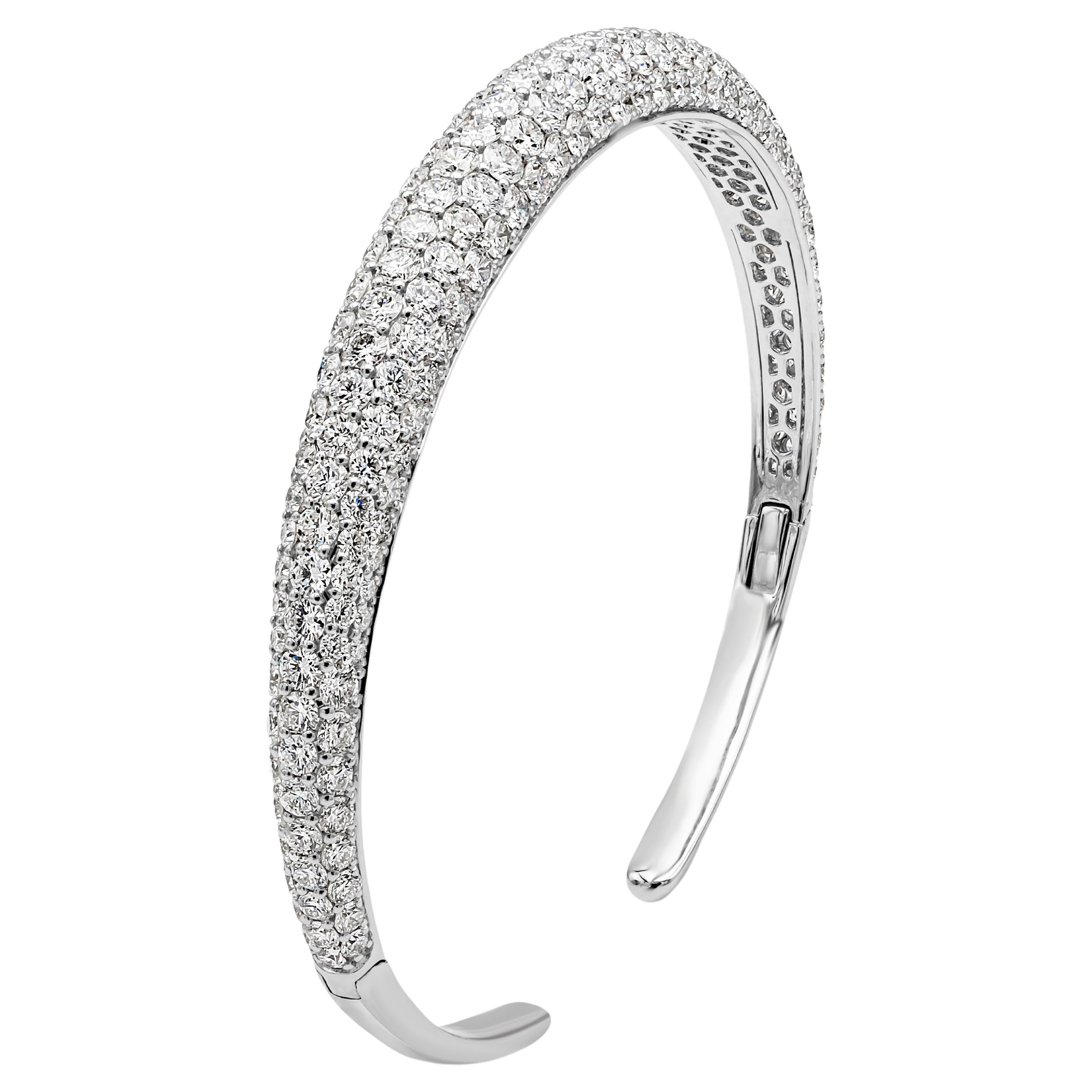 This beautiful and stunning bangle bracelet showcases 209 brilliant round cut diamond weighing 8.05 carats total, F-G color, VS-SI in clarity and micro-pave dome set in a shared prong setting. Finely made in 18K White Gold and 6.75 inches in