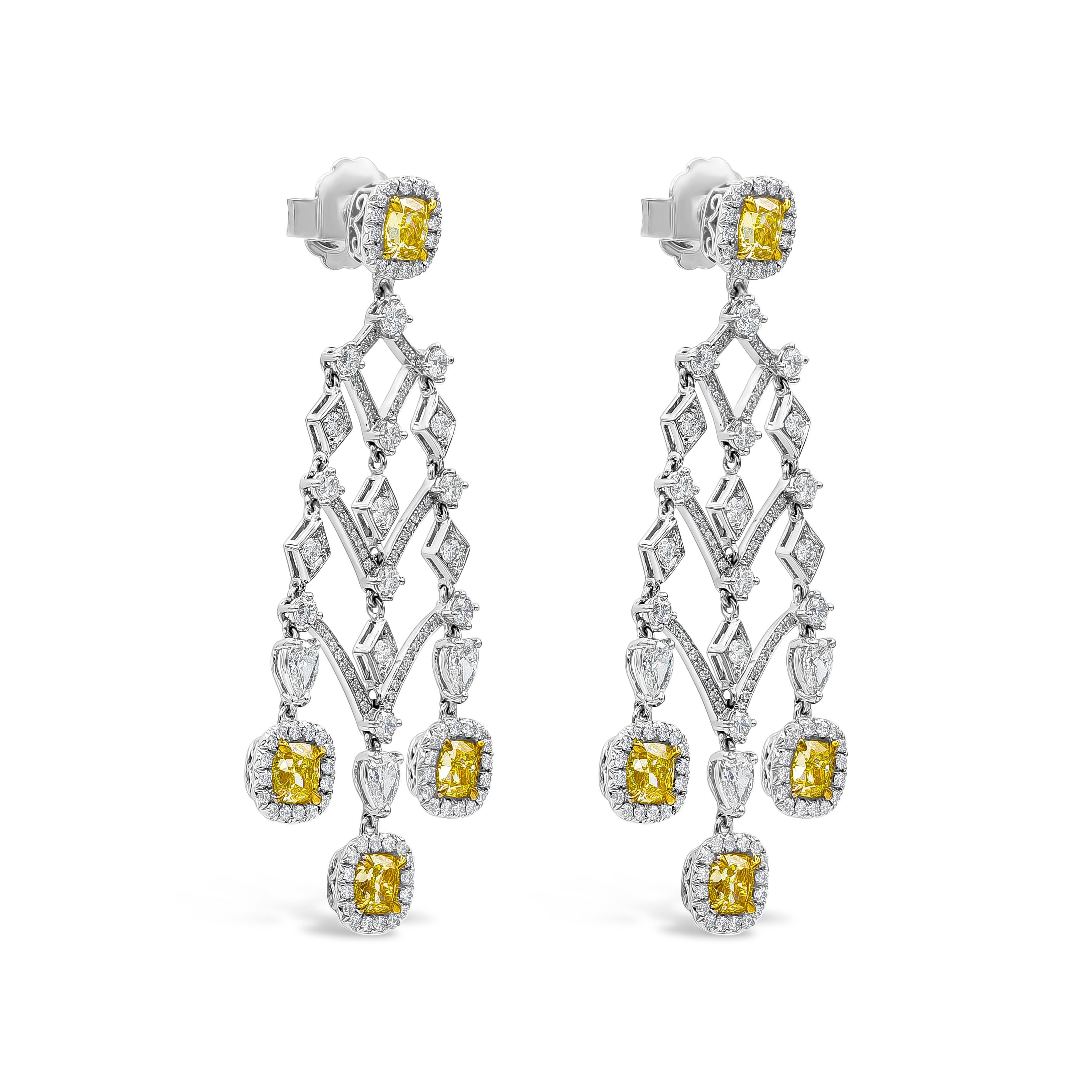 A well-crafted earrings showcasing eight cushion cut fancy yellow diamonds, set in a brilliant diamond halo in an Intricately designed chandelier style. Yellow Diamonds weigh 4.98 carats total; white diamonds weigh 4.41 carats total. Finely made in