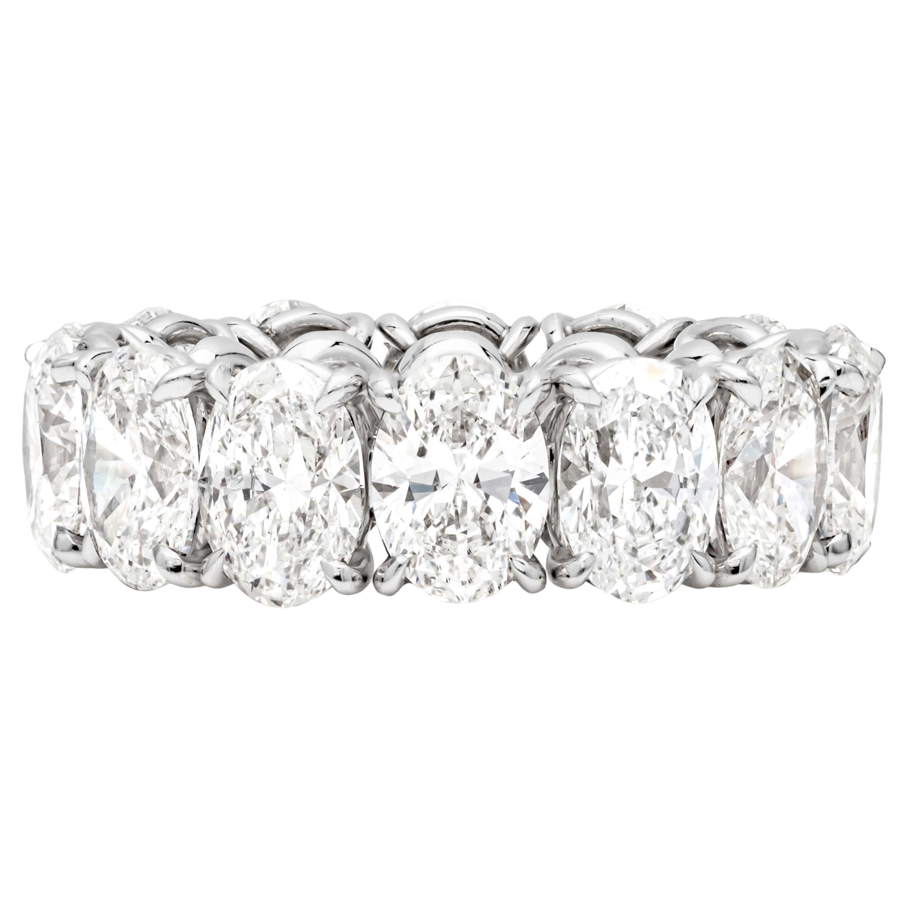 This gorgeous wedding band features 14 brilliant oval cut diamonds weighing 10.25 carats total. Set in an eternity style setting. Each diamond is certified by GIA. The colors of the diamonds range from D-F and VS-SI2 clarity. Made in platinum. Size