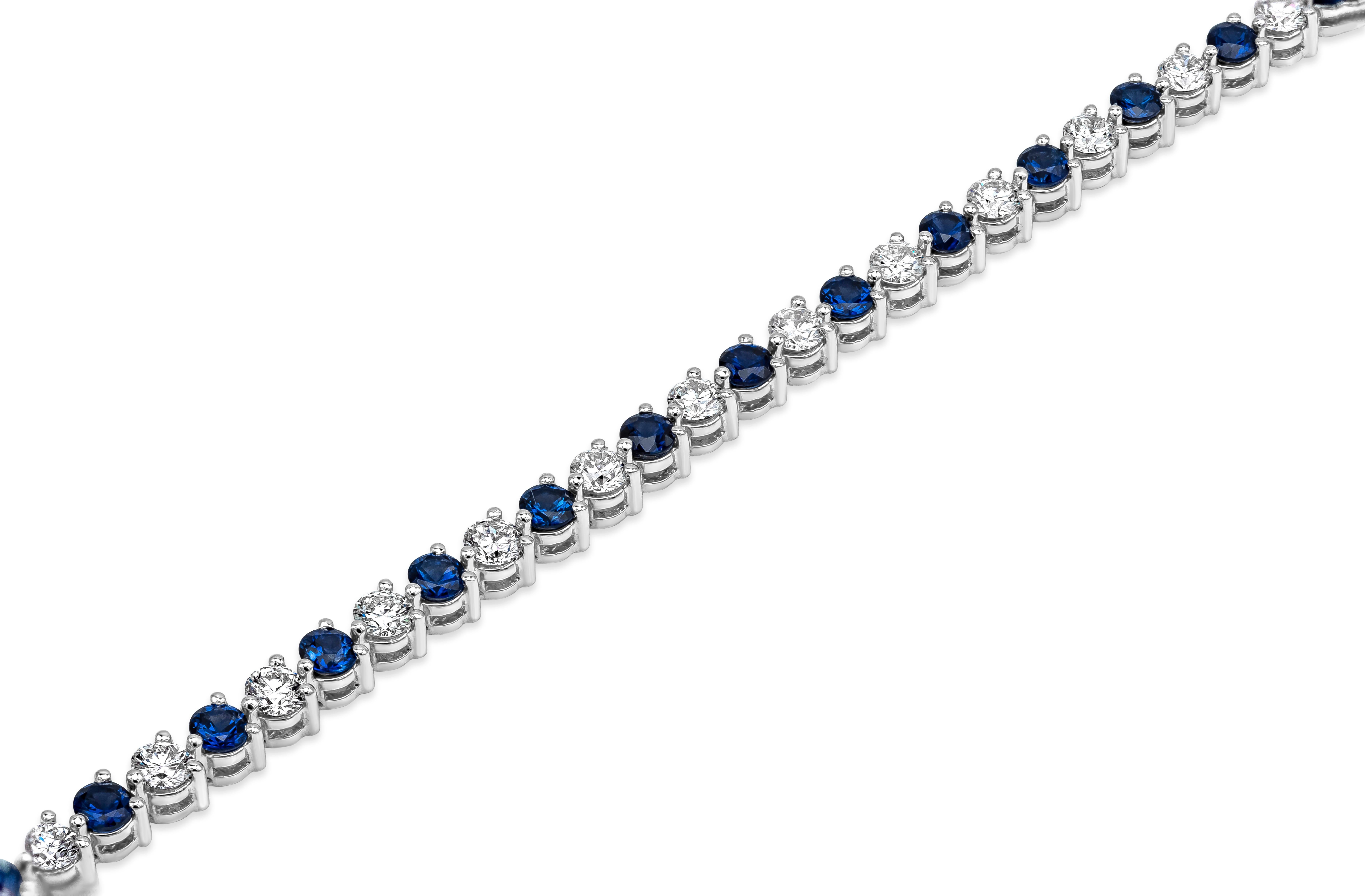 This tennis bracelet features a row of alternating round brilliant cut blue sapphires and round brilliant cut diamonds. Blue Sapphire weighs 4.18 carats    and diamonds weigh 3.36 carats in G-H Color and VS2 in Clarity. Made with 14K White Gold. 7