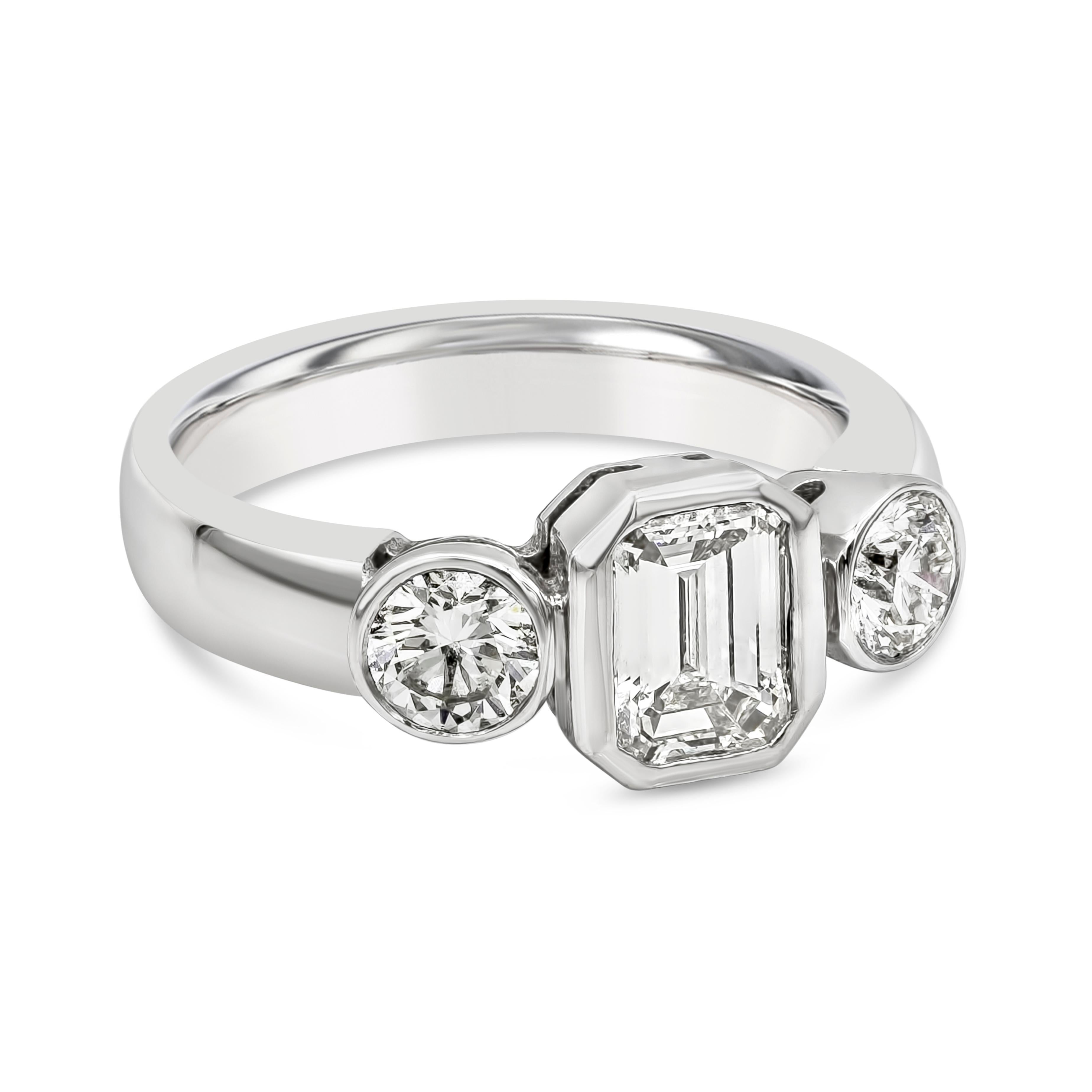 Showcasing a 1.10 carats emerald cut diamond, flanked by a round brilliant diamond on either side weighing 0.62 carats total. Each diamond is bezel set in a polished 18k white gold mounting. Size 7 US resizable upon request.

Style available in