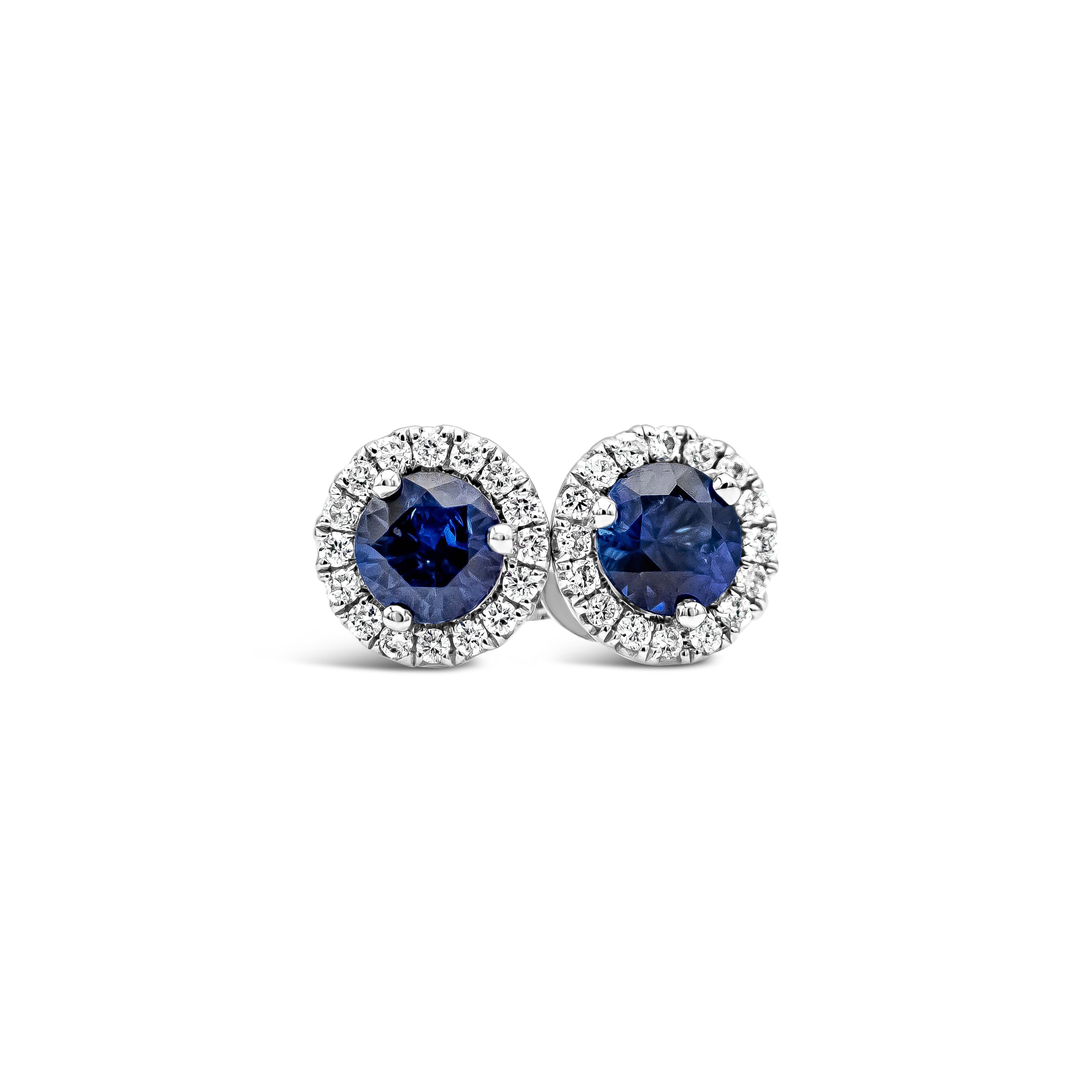 A simple and classic pair of stud earrings showcasing round blue sapphires weighing 0.64 carats total, surrounded by a single row of round brilliant diamonds. Accent diamonds weigh 0.16 carats total. Set in an 18k white gold mounting.

Style