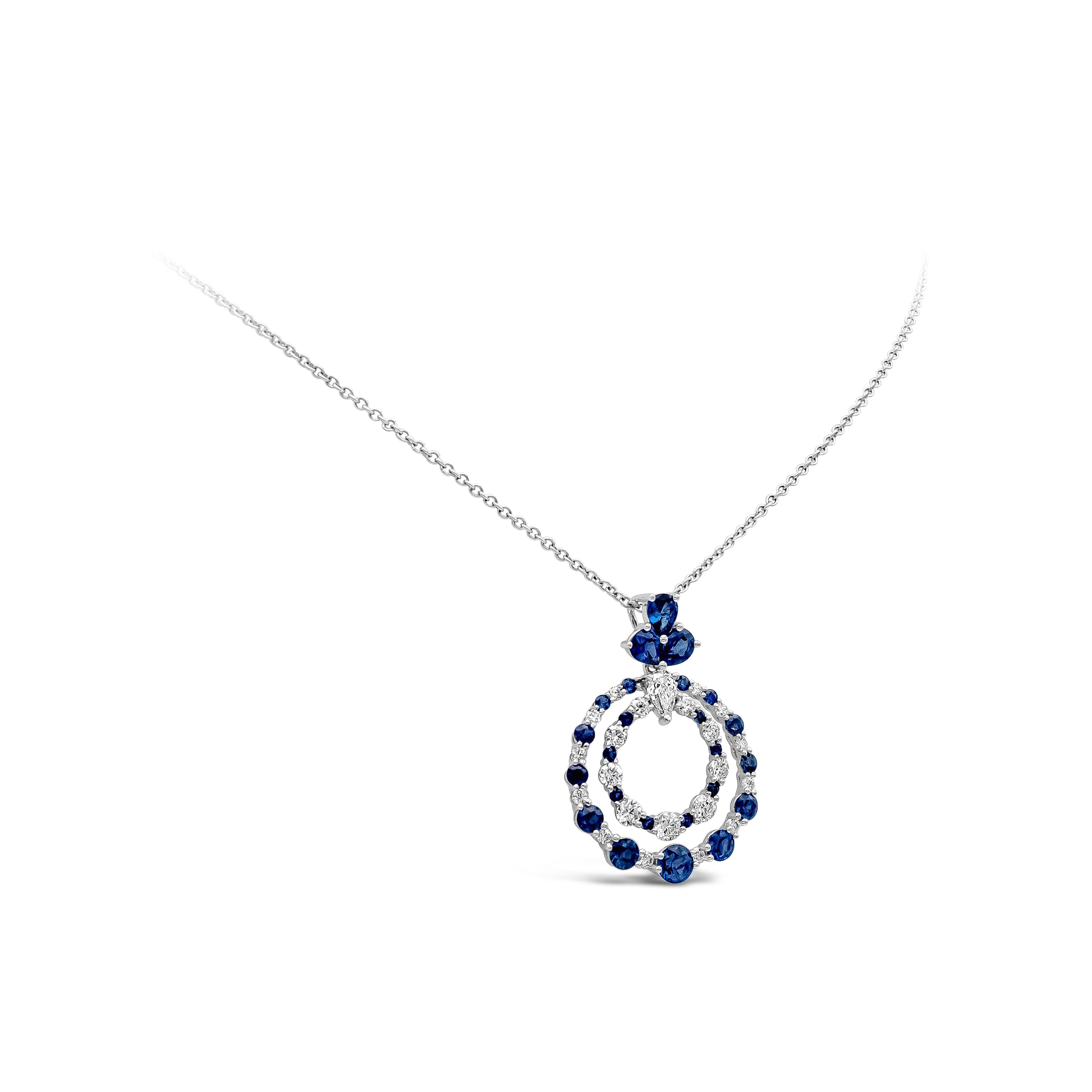 A beautiful and chic pendant necklace showcasing alternating vibrant blue sapphires and round brilliant diamonds, set in an open-work circular design made in 18k white gold. Blue sapphires weigh 1.66 carats total; diamonds weigh 0.72 carats total.