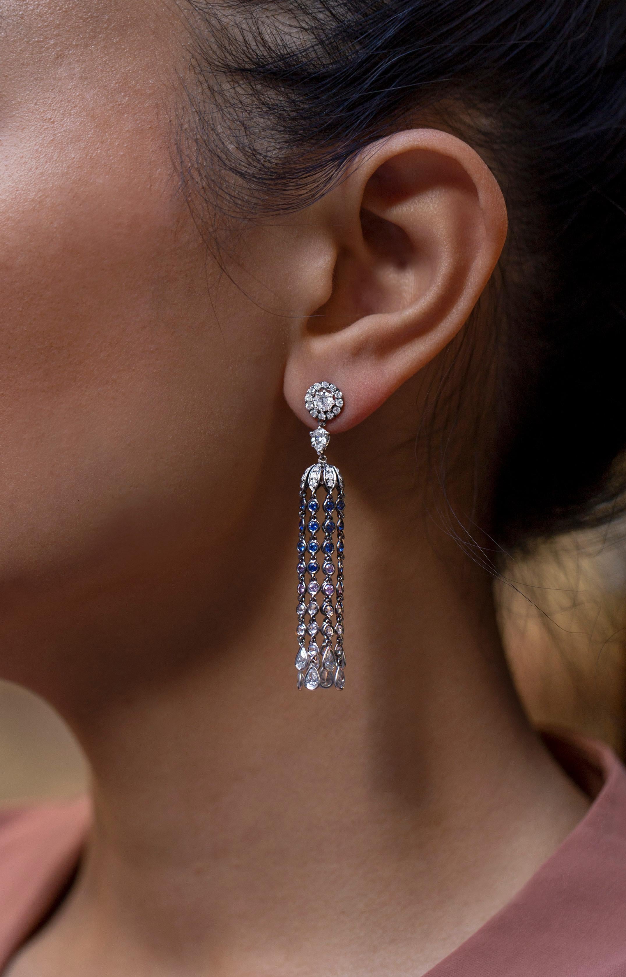 This is an incredibly unique and colorful chandelier earrings showcase 8 long fringes suspending dazzling pear shaped diamonds. Featuring color-rich blue sapphires, pink and white diamonds. Diamonds weigh a total of 3.57 carats, blue sapphires weigh