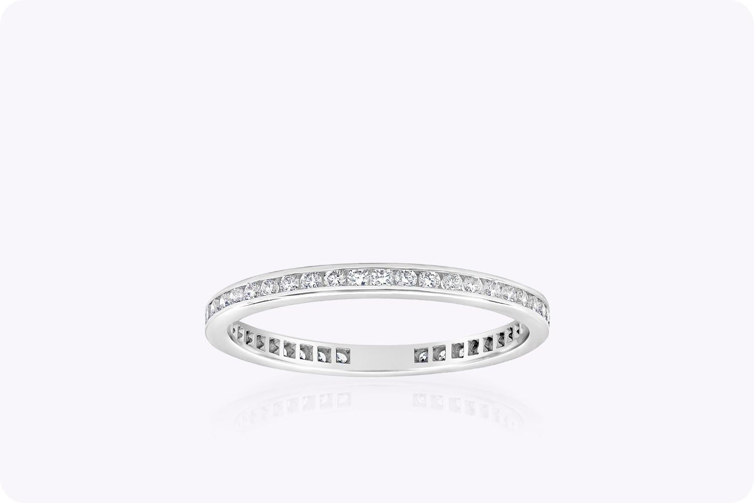 An 18 karat white gold wedding band showcasing round brilliant diamonds in a channel setting. Diamonds weigh 0.38 carats total. Size 6.5 US.


