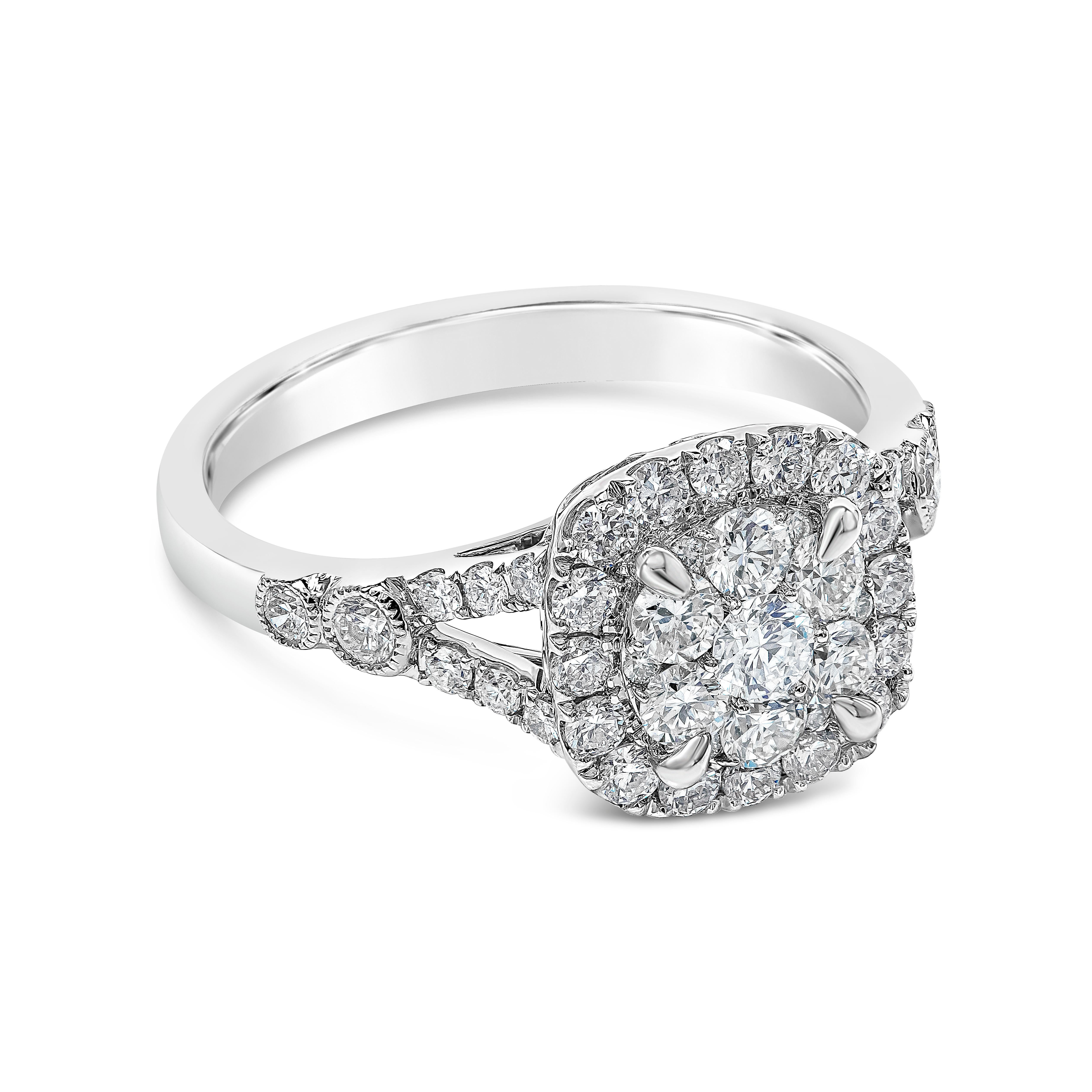 This beautiful engagement ring showcases a cluster of round brilliant diamonds, set in a cushion shape diamond halo. Set in a split-shank mounting made in 14K white gold. Diamonds weigh 0.88 carats total and are approximately G-H color and VS-SI in