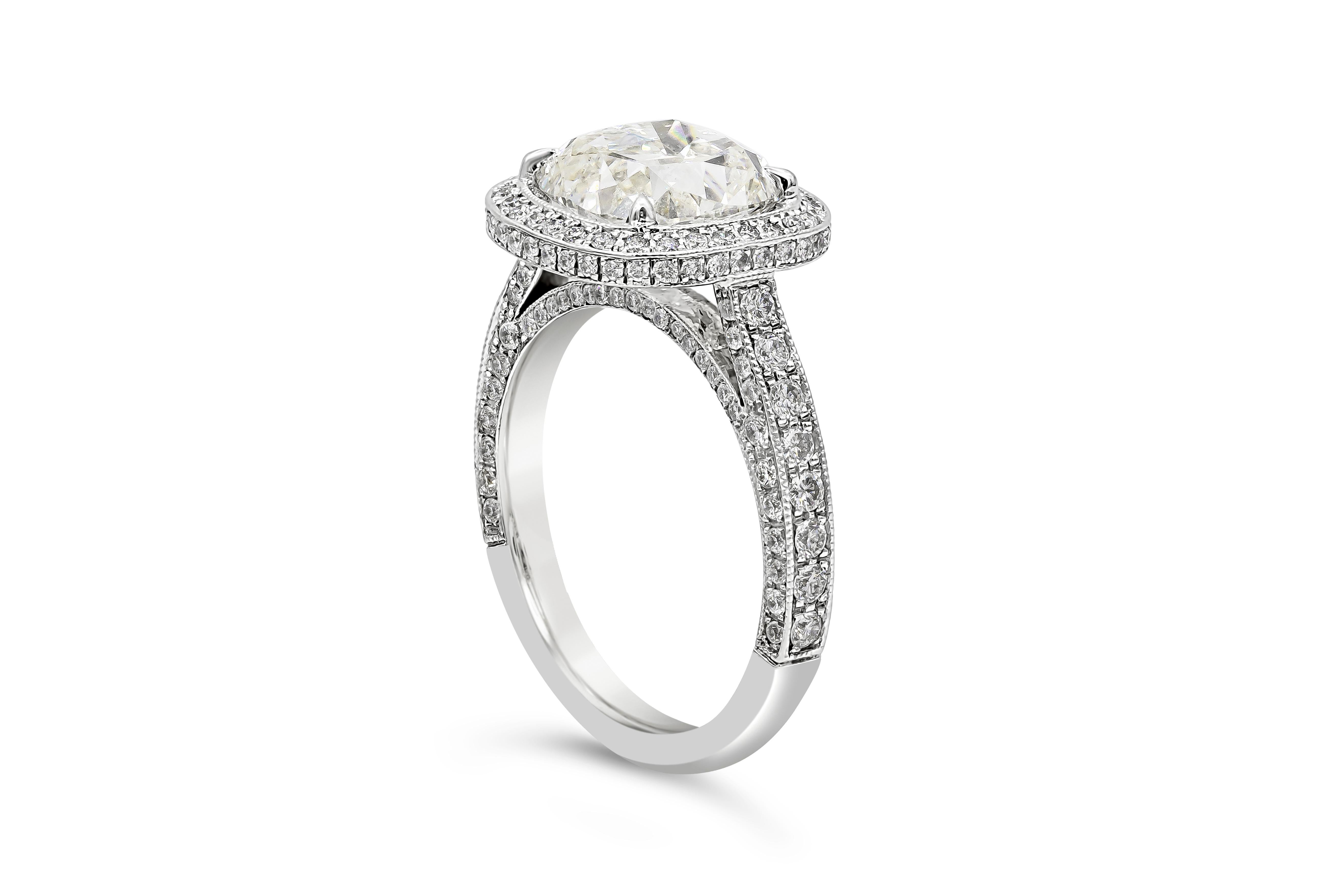 A well-crafted engagement ring style showcasing a 3.02 carats cushion cut diamond certified by GIA as H color, VS2 in clarity, set in an elegant floating halo bezel setting accented with round diamonds. Shank is diamond encrusted made in polished