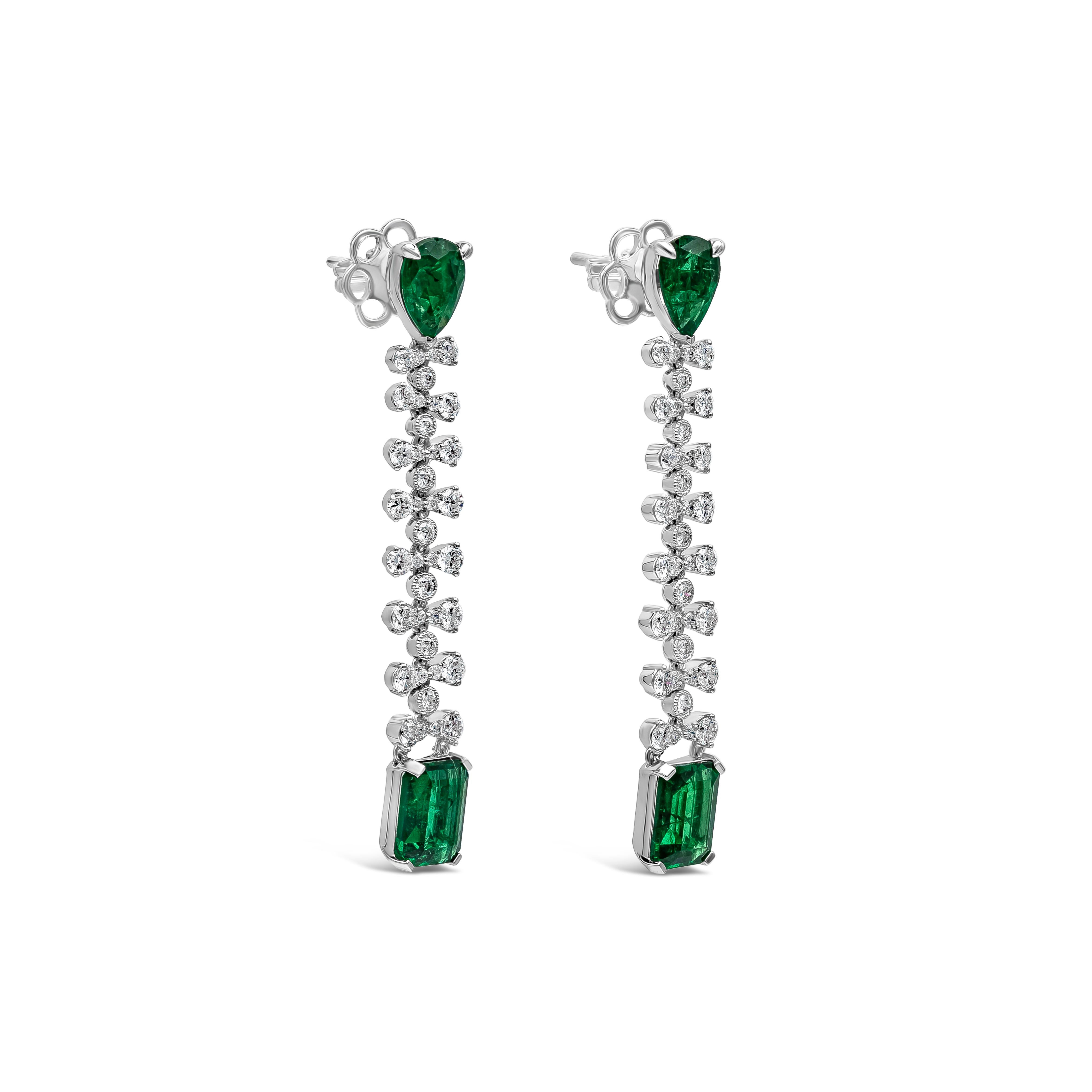 Each earring showcases two oval vibrant green emeralds spaced by round brilliant diamonds, set in a dangle style earrings. Green emeralds weigh 3.10 carats total; diamonds weigh 1.02 carats total. Made in 18k white gold.

Style available in
