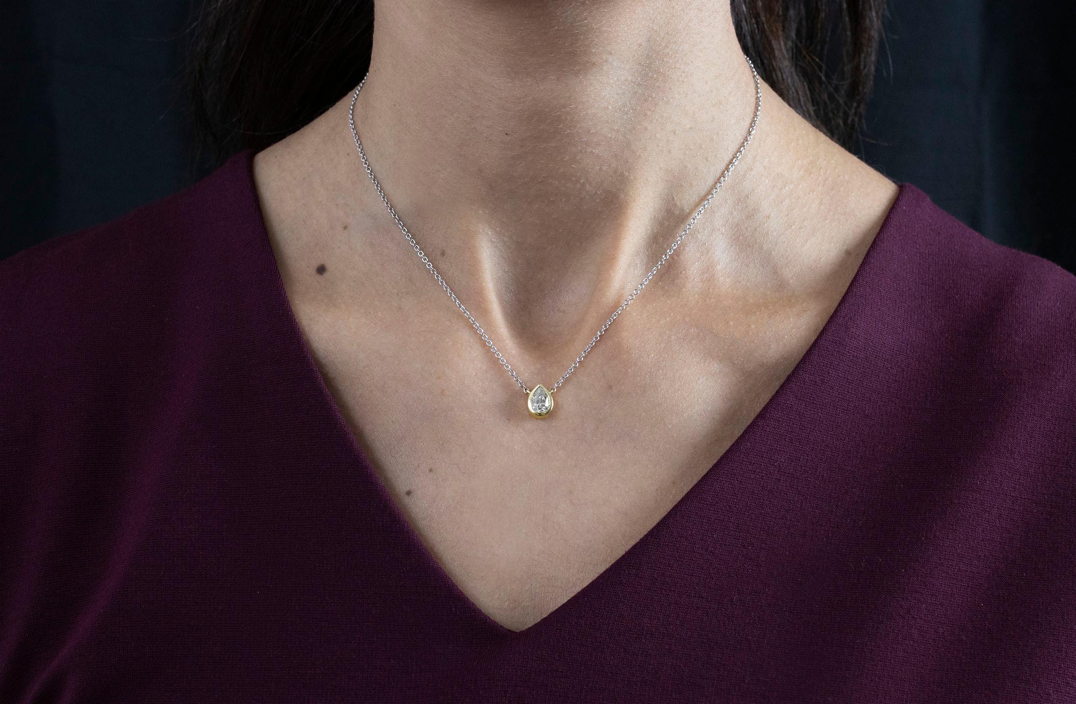 Eine schlichte Anhänger-Halskette mit einem GIA-zertifizierten 0,92-Karat-Diamanten in Birnenform, Farbe L und Reinheit SI2. Lünette in 14K Gelbgold gefasst, aufgehängt an einer 14K Weißgoldkette. 16 Zoll in der Länge. 

Roman Malakov ist ein
