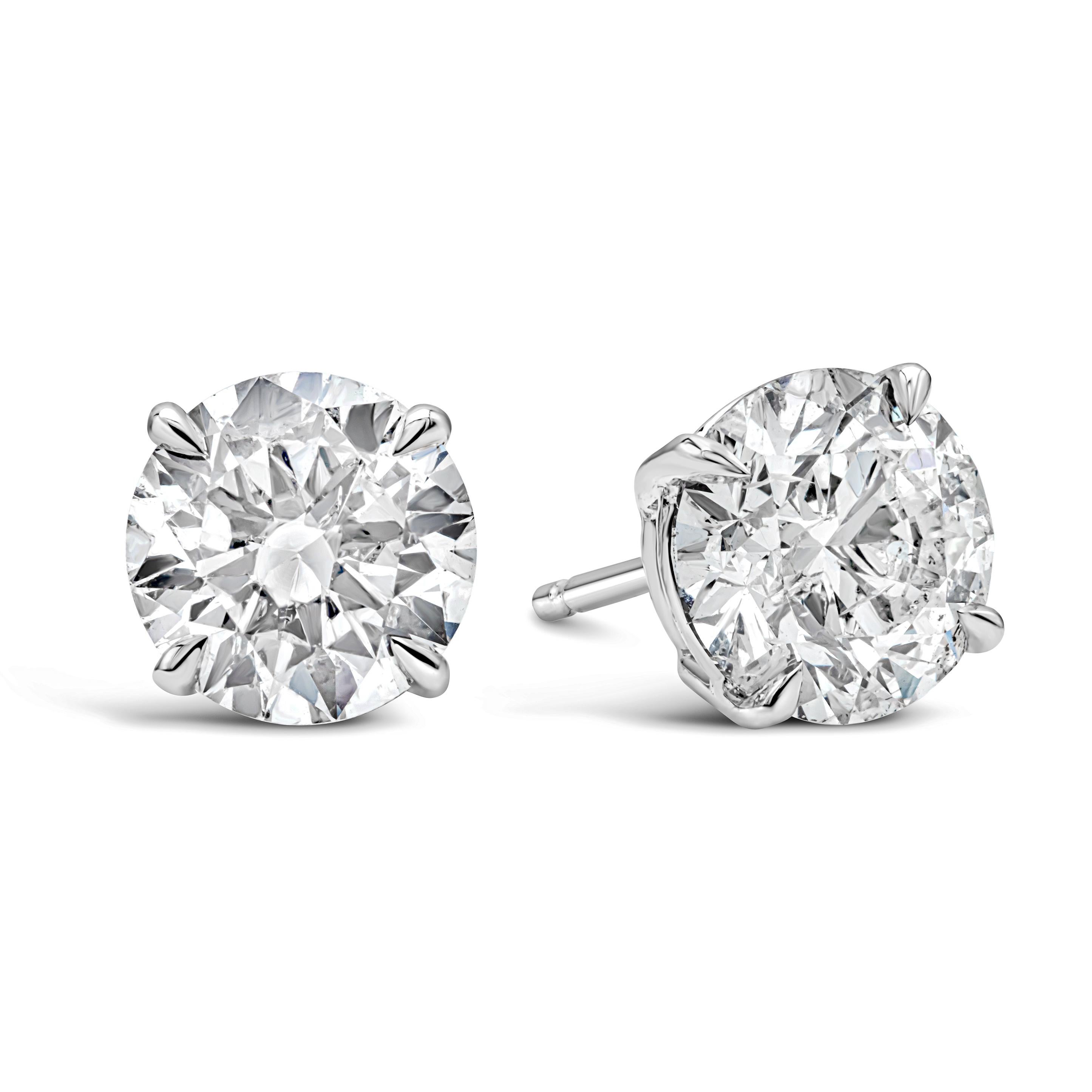 Classic pair of stud earrings showcasing GIA certified two round brilliant diamonds, each weighing 1.20 carats and 1.29 carats respectively. I color with I1 and I2 clarity. Set in a simple four prong, 14 karat and 18 karat white gold