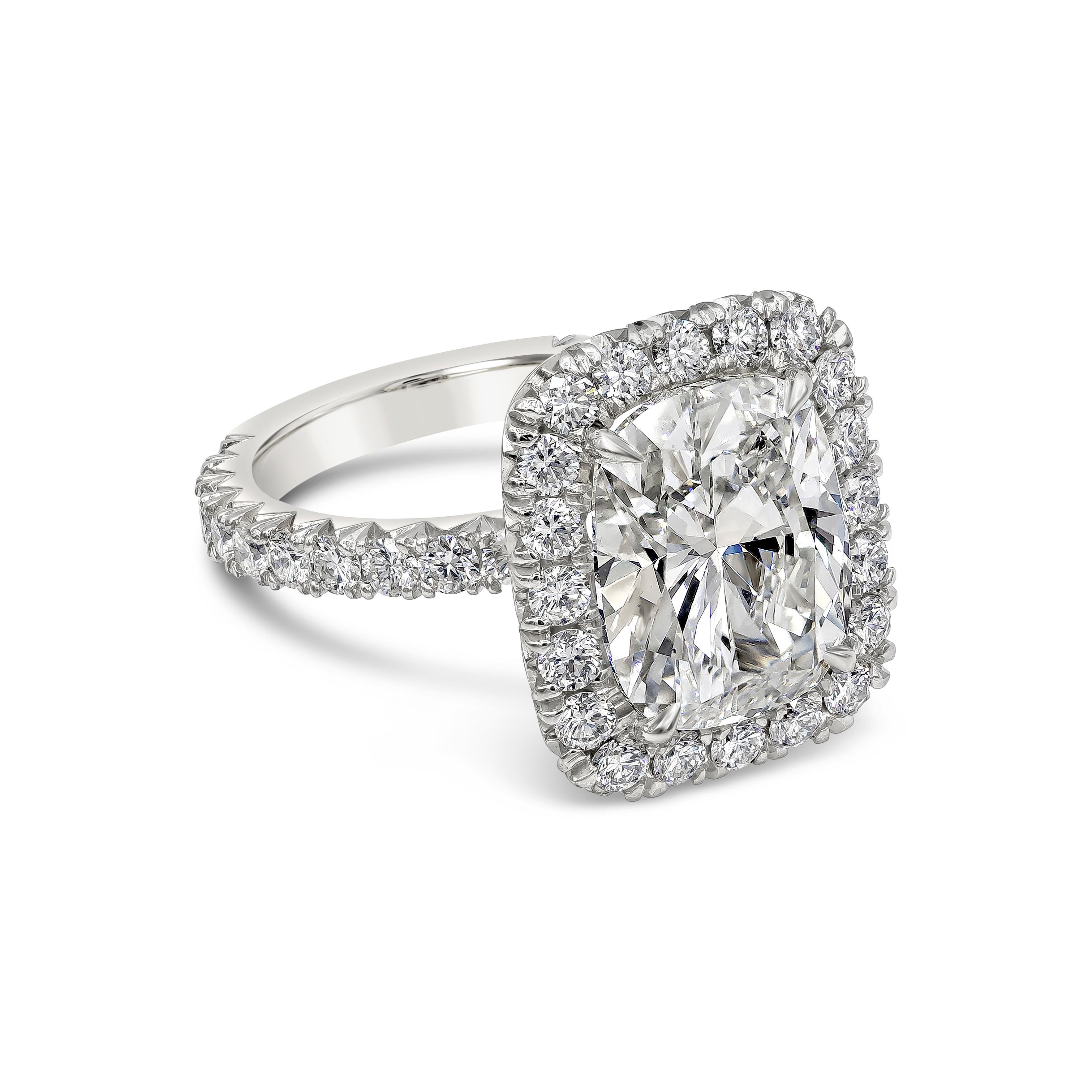 A classic engagement ring style showcasing a 5.01 carats cushion cut diamond, GIA Certified as J Color and VS2 in clarity. The center stone is surrounded by a single row of halo round brilliant diamonds and the shank is diamond encrusted. Accent