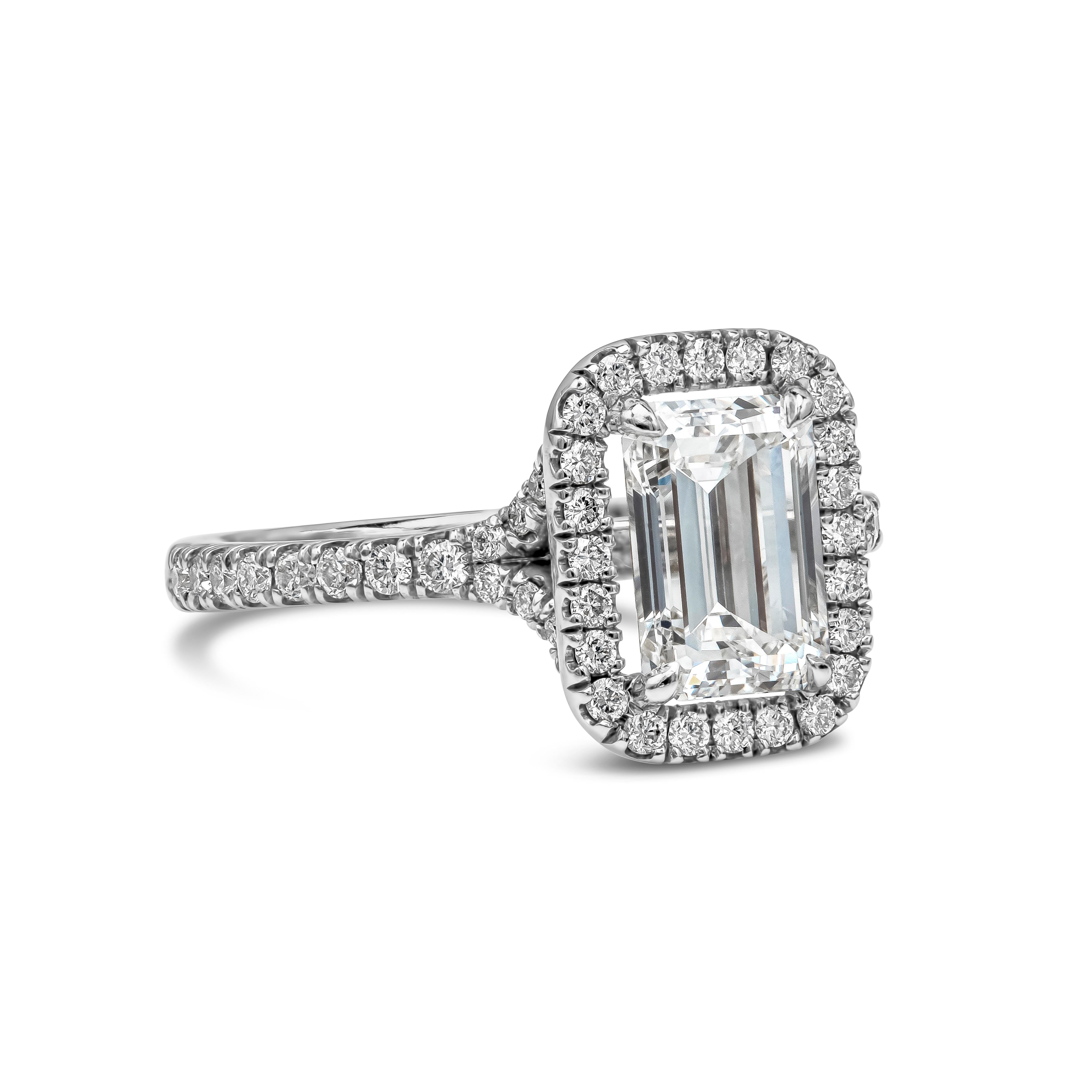 Features a 1.60 carats emerald cut diamond certified by GIA as F color and VS2 in clarity. Surrounded by a single row of round brilliant diamonds in seamless halo setting. Shank is diamond encrusted in half eternity setting made in 18K white gold.