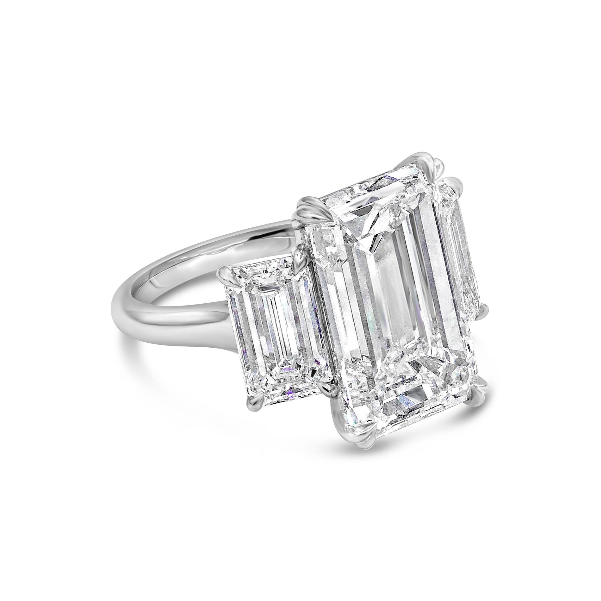 A classy high end jewelry engagement ring showcasing a center stone weighing 9.82 carats emerald cut diamond certified by GIA as G color and VVS1 in clarity. Flanking the center diamond are two emerald cut diamonds as GIA certified E-F Color and