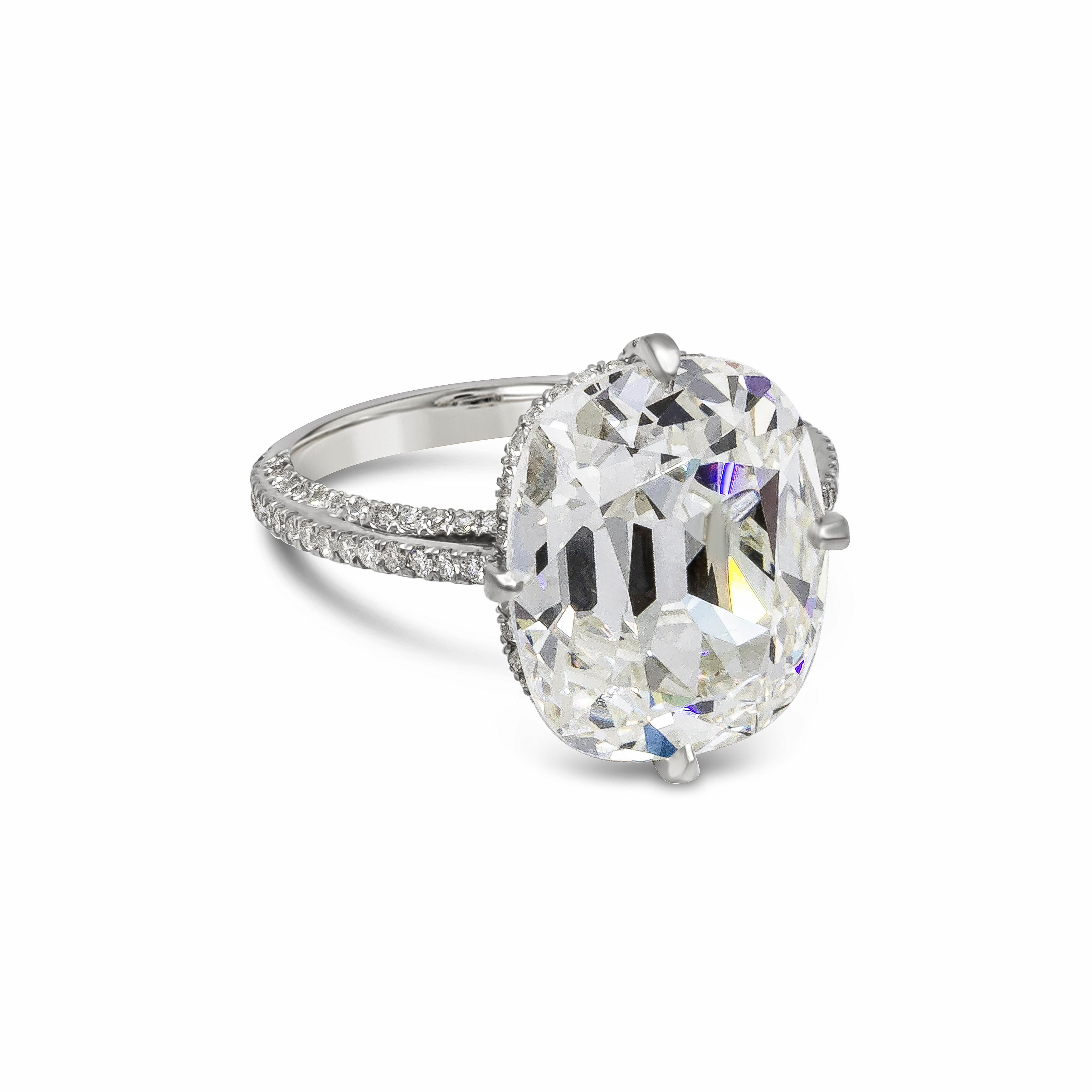 A spectacular engagement ring, showcasing an 8.94 carats old mine cushion cut diamond certified by GIA as J color and VVS2 clarity, set on a unique compass setting. Accented by 152 round cut diamonds weighing 0.78 carat total, set on a pavé