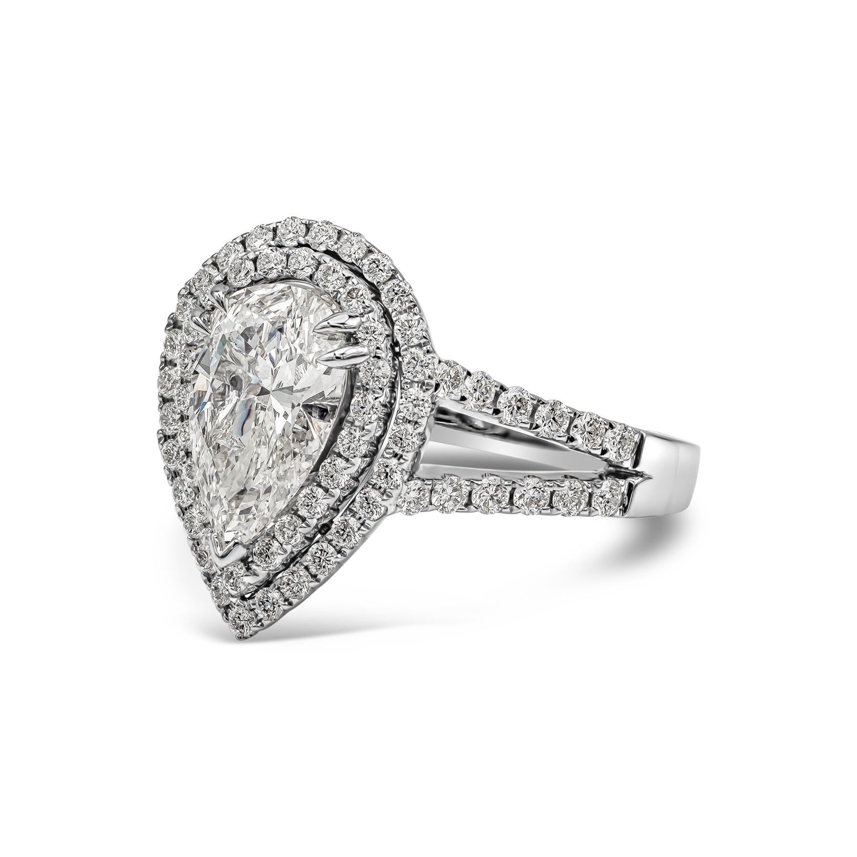 Showcasing a 1.53 carats pear shape diamond certified by GIA as H color, VS1 in clarity; surrounded by two rows of round brilliant diamonds in an accented split-shank setting made in 18k white gold. Accent diamonds weigh 0.71 carats total. Size 6.75