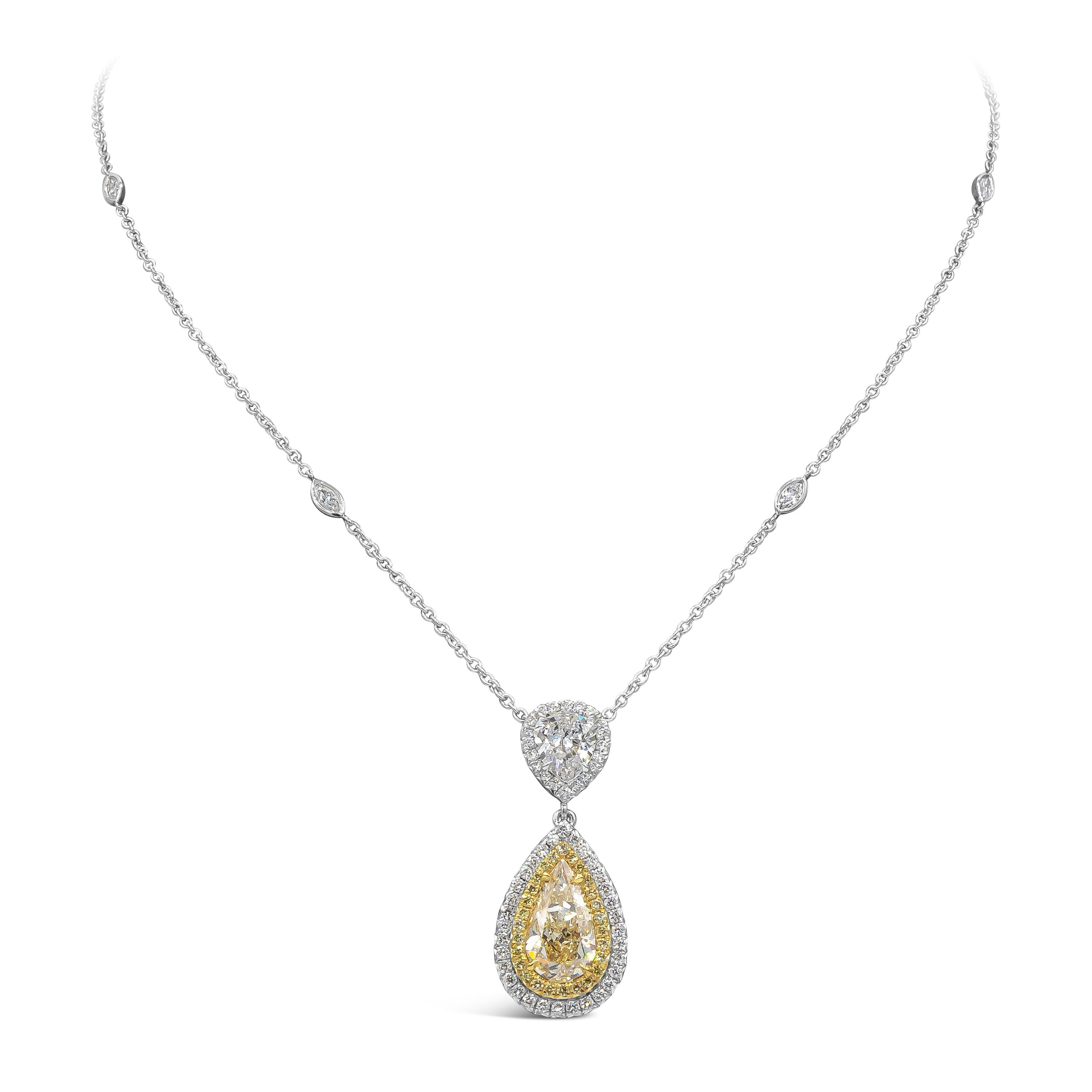 Showcasing a 2.07 carat pear shape yellow diamond certified by GIA as U-V color. Surrounding the center diamond are two rows of round brilliant yellow and white diamonds. Suspended on another 1.02 carat GIA certified (F-SI2) diamond halo. Attached