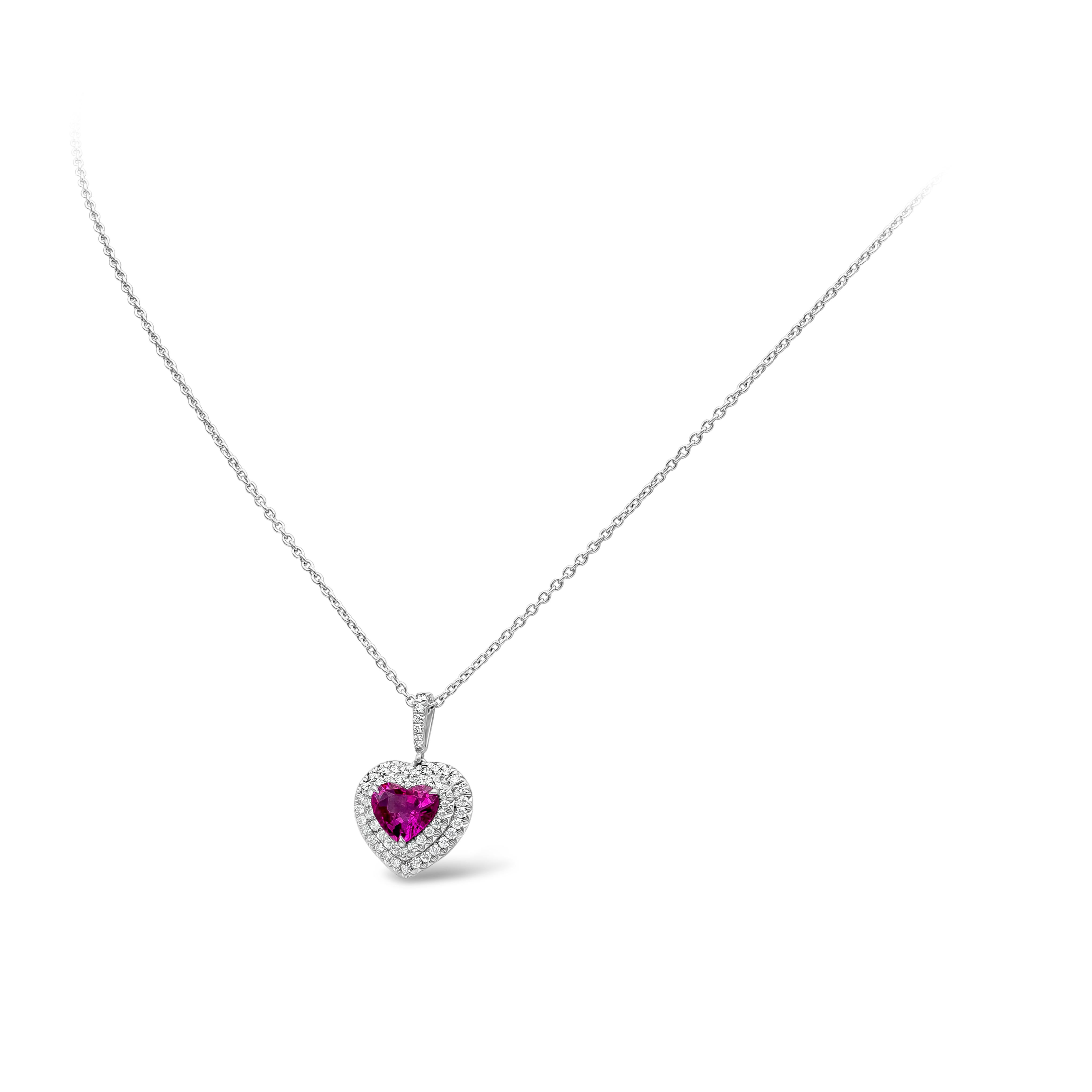 A beautiful and versatile pendant necklace showcasing a vibrant 1.82 carat heart shape pink sapphire certified by GIA as having no indications of heat treatment. Center stone is surrounded by two rows of round brilliant diamonds that weighs 0.49