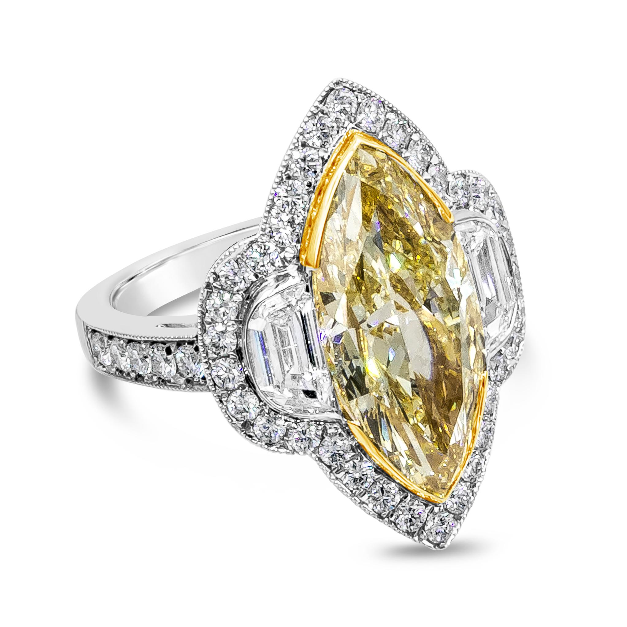Showcasing a GIA Certified 5.43 carat marquise cut diamond center stone, Fancy Yellow color, VVS1 clarity. Flanking the center diamond is two half moon diamonds weighing 0.79 carats total. Set in an intricately designed setting accented with round