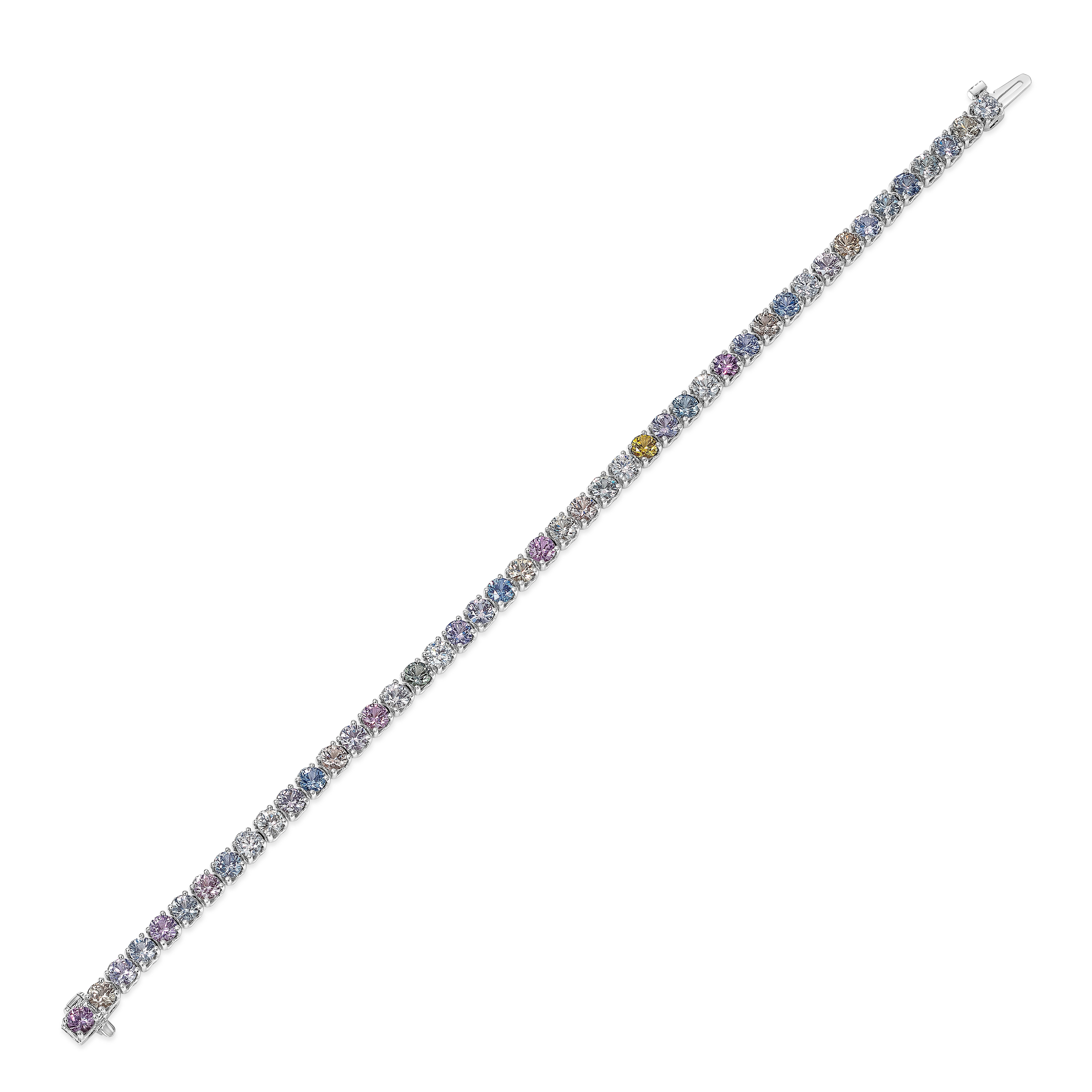 A gorgeous and unique tennis bracelet showcasing a row of round multi-color sapphires, and round brilliant diamonds, set in a polished 18K white gold mounting. Sapphires weigh 8.56 carats total, MC color and VS in Clarity. Diamonds weigh 0.88 carats