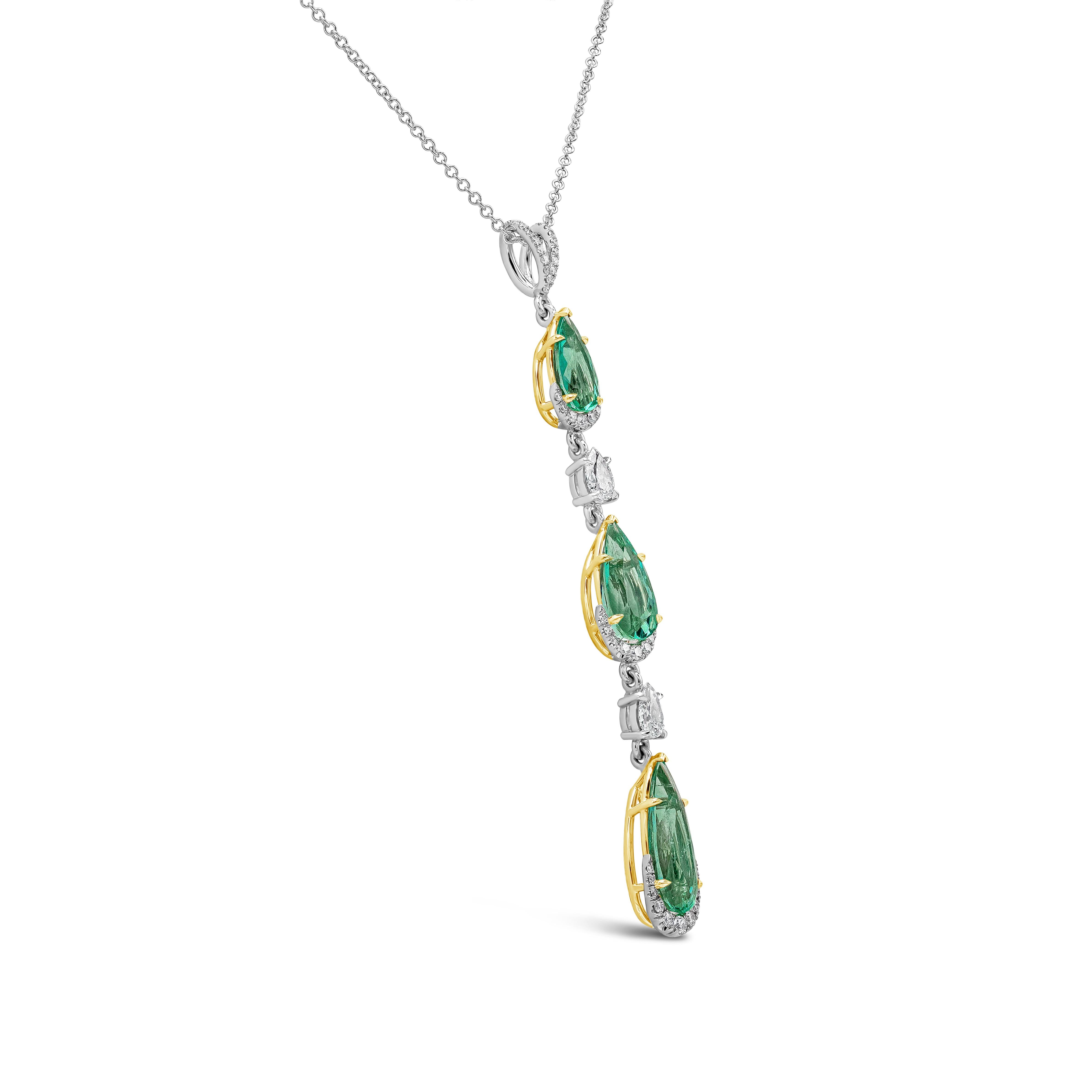 A fashionable pendant necklace showcasing three graduating pear shape emeralds, spaced by brilliant pear shape diamonds. Emeralds are Colombian origin and weighs 5.50 carats total. Diamonds weigh 0.81 carats total. Made in 18k yellow gold and