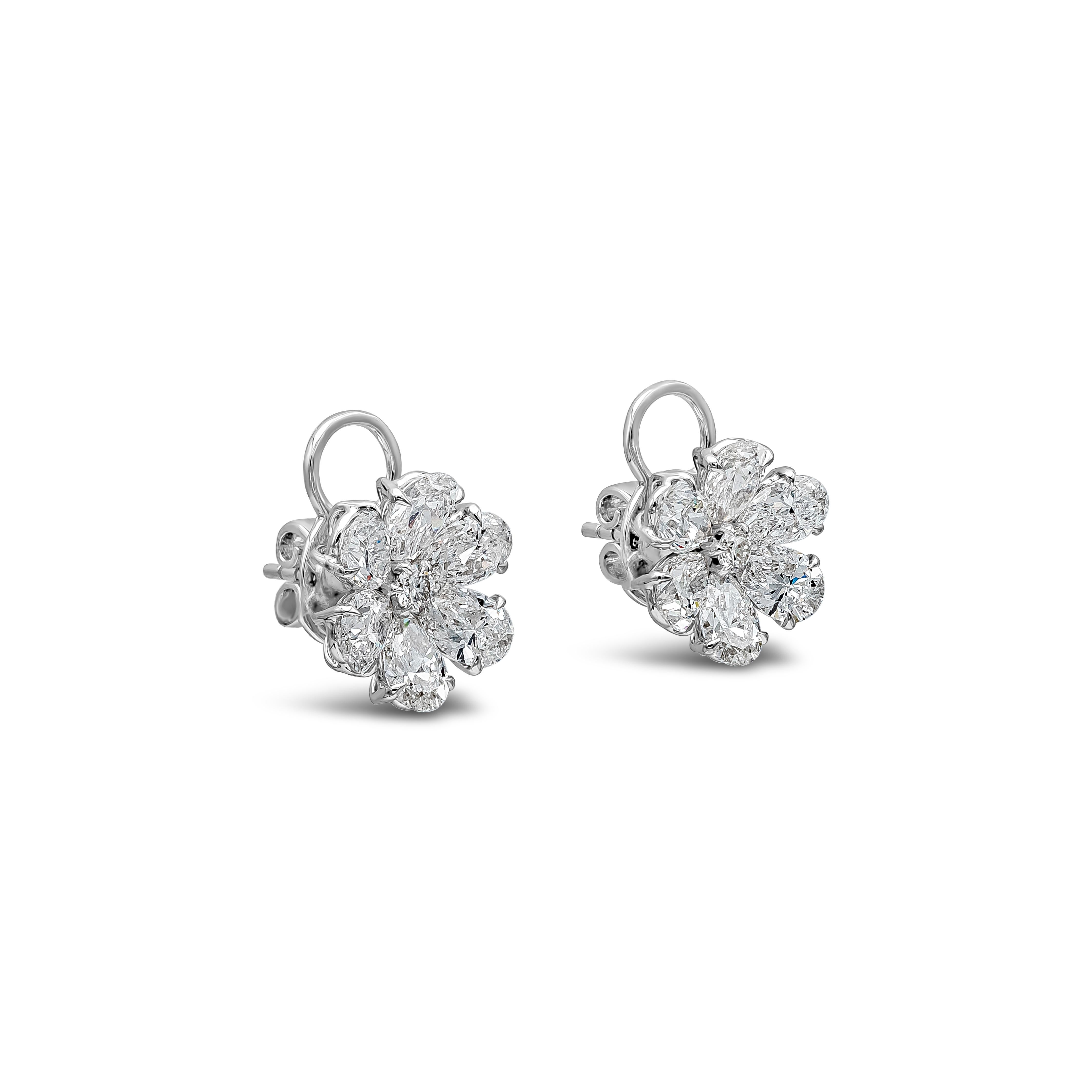 A simple yet unique piece of stud earrings showcasing 0.20 carats total brilliant round cut diamonds, D-E color, VS in clarity. Surrounded by a clusters of pear shape diamonds arranged in a flower-motif design weighing 6.10 carats total and
